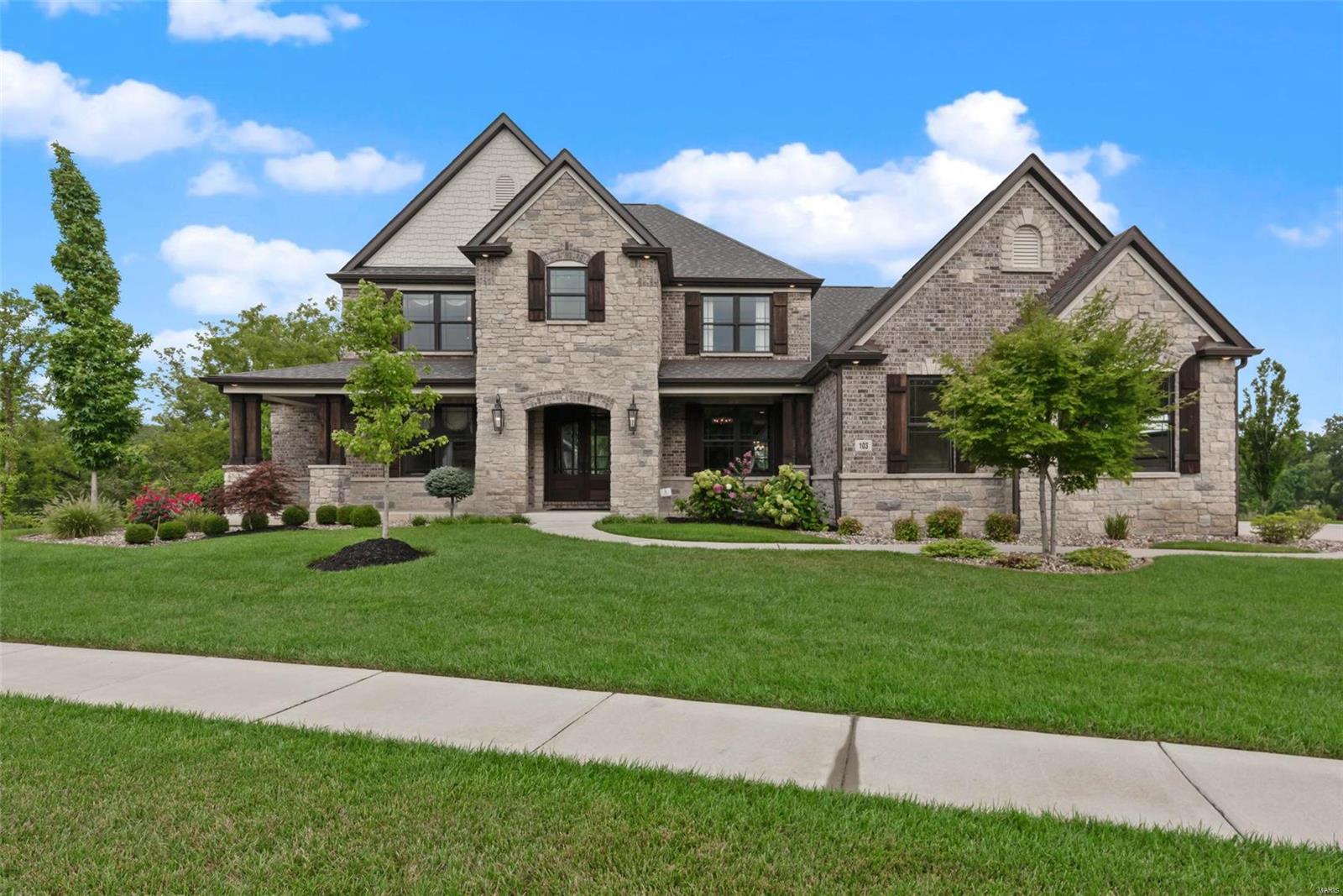 This luxurious Lombardo-built showplace is filled with exquisite custom features, including a chef's kitchen w/butler's pantry & commercial-grade SS appliances, like a 6-burner Electrolux gas range & chimney hood w/pot-filler faucet, double ovens, Frigidaire Pro fridge/freezer, Electrolux double cooler drawers, & a glass front refrigerator in the landing room off the 3-car side-entry garage. 2-story great room w/wall of windows & gas fireplace flanked by lighted built-ins. 4-season room opens to the covered, lighted deck w/42" wood-burning fireplace. Luxurious main floor owner's suite w/custom walk-in closet organizers & spa-like bath w/Kohler freestanding tub & multi-head shower. Upstairs is a loft & 3 spacious bedrooms w/walk-in closets & private bath access. Durable James Hardie siding & brick wrap around the sides & back, with over a 1/2-acre irrigated, landscaped, level yard. Walk-out lower level w/9' pour. Estate neighborhood served by Wentzville (Liberty) Schools. See it today! Additional Rooms: Mud Room, Sun Room