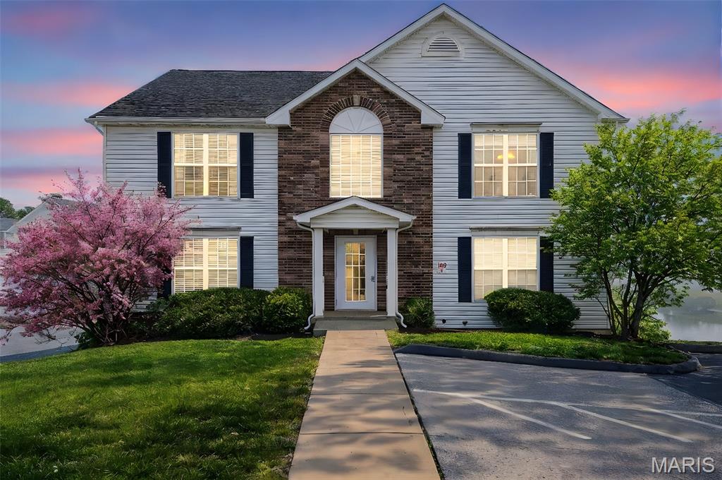 This main-level condo offers an incredible combination of comfort, convenience, and lifestyle! Backing to a peaceful neighborhood lake, you’ll enjoy beautiful balcony views in a serene setting. Located directly across from the neighborhood pool, the location couldn’t be better. Inside, the home features new flooring that adds a fresh, modern feel throughout the main living areas. The open-concept family and dining rooms flow seamlessly into the kitchen, complete with a breakfast bar, pantry, and recently updated appliances—perfect for everyday living and entertaining. The spacious primary suite includes a private bath. You’ll also appreciate the private main-level laundry. Enjoy the convenience of no-step entry, parking directly in front of the building, plus a garage and a large 12x11 private locked storage room below. The HOA covers yard care, exterior maintenance, some utilities, and insurance—making for low-maintenance living. Roof is newer.  Residents enjoy access to fantastic neighborhood amenities including pools, basketball courts, playgrounds, walking trails, disc golf, and horseshoe pits. Conveniently located near I-70 and Hwy 79 with easy access to shopping, dining, and everyday conveniences. Schedule your private tour today!