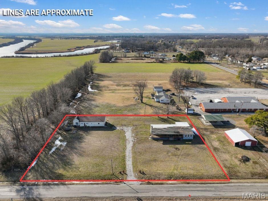 Situated on approximately 1.52 acres, this property includes two parcels being sold together. The  primary residence offers 2 bedrooms and 2 full bathrooms. The additional parcel features a 3-bedroom, 2-bath mobile home complete with a welcoming front porch and sunroom. Properties need TLC and are being sold as-is.