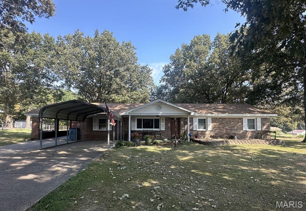 Welcome home to this spacious 1,680 sq. ft. brick home filled with comfort and amenities! The living room features crown molding, laminate flooring, a decorative built-in opening to the dining room, and an electric fireplace that stays. Sliding doors overlook the generous 105 x 150 lot. The kitchen offers a stainless side-by-side refrigerator, dishwasher, 5-burner gas cooktop and double oven. Three spacious bedrooms include a primary bedroom with adjoining half bath, plus an updated full bath with tub/shower and vanity. Enjoy newer tilt-in thermopane windows with screens, a smart thermostat, EUFY security cameras and a media room with riser for your sofa. Improvements include a 2022 architectural roof, aluminum soffit and fascia, and added attic insulation. Outside are an attached 14 x 28 carport, freestanding 12 x 20 metal carport and 12 x 16 frame building with wood floor. Ameren gas/electric, Public Water District #1 and 1,000-gallon septic. So much to enjoy!