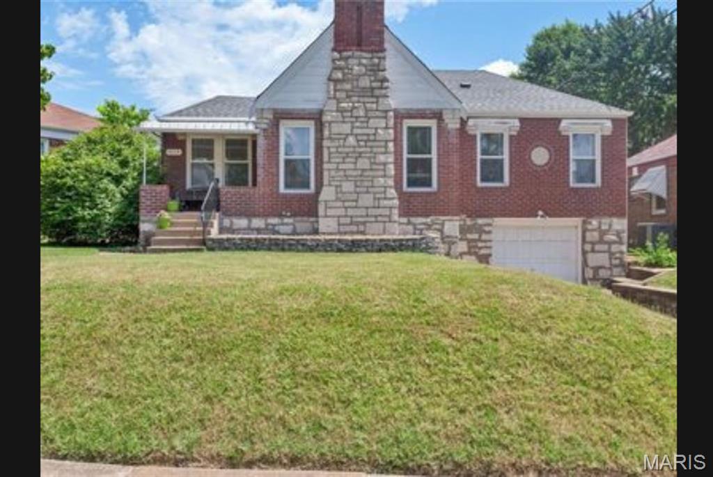 Short Sale Opportunity! This home boasts incredible curb appeal with its classic brick and stone front, mature trees, and a covered porch. Step inside to find a classic interior featuring a spacious open floor plan and hardwood floors. The living room serves as the perfect gathering space, highlighted by a beautiful wood-burning fireplace with a stone surround. Just off the functional kitchen—which is packed with cabinet space, counter space, and classic ceramic tile walls—is a sun-drenched sunroom. The kitchen also provides direct access to the backyard complete with a patio for easy outdoor entertaining. Rounding out this impressive property is a one-car attached garage and a convenient basement with a 1/2 bathroom.  Don’t miss out on this value-packed opportunity!