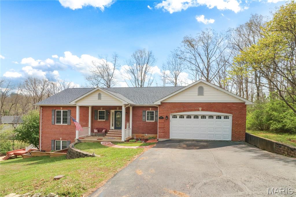 Welcome Home! Beautiful partial brick 3-bedroom 3-bath ranch style home with over 3500 sq feet of living space. Home has an open floor plan with vaulted ceilings, wood floors, living room with a fireplace, spacious kitchen with ample cabinets including dining room area that walks out to one of the two decks. Main floor master suite includes walk-in closet, whirlpool tub and separate shower. Finished walkout basement provides plenty of room to entertain and a second fireplace. Home also features main floor laundry and central vacuum system. Home has been well maintained with a newer roof and HVAC.  Enjoy your time on the deck or around the firepit. Terre Du Lac is approximately one hour south of St. Louis featuring 15 lakes, 18-hole golf course, pickle ball court, dog park and more.  Home is a must see to see all it has to offer.  Additional attached lot available with house with lake access.