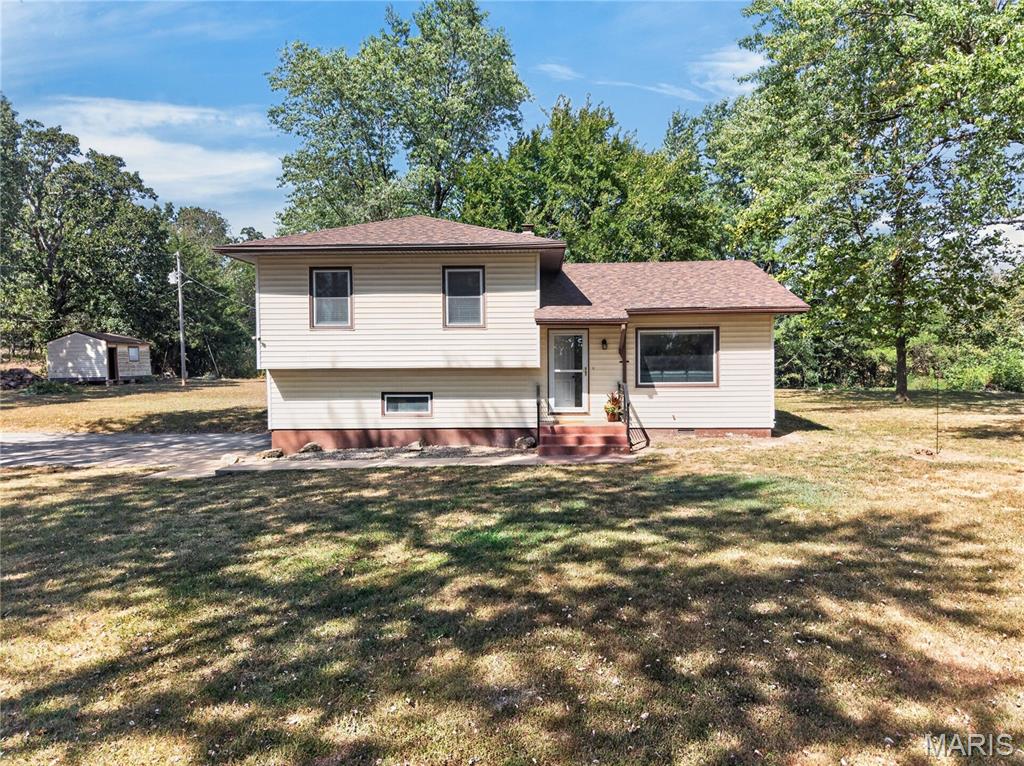 This four bedroom, one and a half bathroom home sits on almost an acre outside of city limits and gives you country living on a mini scale! As you enter the main level of the home you are invited into an open concept living area which is perfect for those intimate family evenings, but also gives you a large space for entertaining. Moving upstairs you have three bedrooms and a full bathroom that gives everyone plenty of room to spread out. As you enter the lower level of your home there is an additional half bath and fourth nonconforming bedroom, office, or additional den for even more space. Moving outside to your expansive yard there is more than enough room for pets, chickens, goats, and a garden area! This little slice of Heaven is everything you've been searching for, take a look today! Listing agent is property owner.