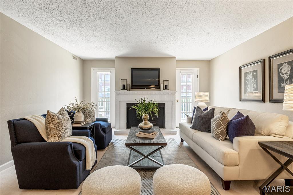 Tastefully updated 1-level condominium located in a well-maintained complex with award-winning Parkway schools.  Open floor plan features newly installed carpeting, neutral interiors & large windows that draw in an abundance of natural light. Gracious entry foyer leads to formal dining room and adjacent living room with brick fireplace flanked by atrium doors that open to covered deck. Bright open kitchen with solid surface countertops & stainless steel appliances adjoins light-filled breakfast room. The primary bedroom offers an appealing retreat with expanded walk-in closet & ensuite bath. Fully secure building with elevator, storage unit & 2 garage spaces. Community pool & gazebo are just steps away. Convenient Chesterfield location only minutes from shopping, restaurants & parks with easy access to Hwy 40.