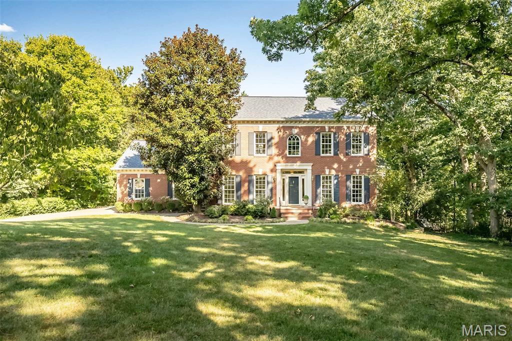 INCREDIBLE NEW PRICE! Here is a rare opportunity to acquire this stately, move-in ready custom-built home that's perfectly positioned on a breathtaking .87-acre lot (100 x 380) in one of Kirkwood’s most picturesque and scenic settings! This beautiful home sets the stage for an unforgettable first impression both inside and out. From it’s classic exterior architecture, superior custom construction with brick facade, Palladian and double hung windows that are metal clad and wood interior, wood burning fireplace and gas burning fireplace; to it’s exceptional interior craftsmanship with wainscoting, crown moldings, curated finishes such as newly painted neutral walls, timeless high end porcelain tile, wool carpet, wood floors that are newly finished and paired fixtures you will have experienced this seamless impressive quality throughout. Upon entering, you're welcomed by a warm and inviting foyer that graciously introduces the well designed living spaces, showing you the heart of the home that awaits you. The quaint/cozy living room features two stunning floor to ceiling double hung windows, a simple but elegant custom wood gas fireplace with marble surround and hearth and cove moldings at the ceiling. The dining room replicates the two stunning floor to ceiling windows and cove moldings but has an additional 3rd window (looking to the privacy of the woods) and chair rail. The open end of the dining room is situated to where it opens to the family room to see the beautiful custom crafted wood burning fireplace and to provide opportunity for larger memorable gatherings and special occasions. Extending across the rear of the home, the richly appointed family room as mentioned showcases floor to ceiling windows looking out to the back patio and woods, remarkable Amish-crafted custom cherry solid wood built-ins cabinets with shelving for display and storage for visual and audio, again the fabulous wood burning fireplace accented by exquisite 6 x 6 hand-painted Dutch inspired tile surround. Designed with both style and functionality in mind, the well appointed eat-in kitchen is sure to impress with its beautiful solid wood Cherry cabinetry (Amish-crafted!), attractive quartz countertops, 4 x 4 hand painted tiles and NEW LG stainless steel appliance package. Conveniently located off the kitchen is a stylish powder room with pedestal sink along with an adjoining oversized main-floor laundry room that enhances both practicality and everyday ease. Up the staircase awaits the spacious primary suite with three luscious light filtering windows complete with generous closets and a lovely bath featuring a spacious walk-in shower, designer cabinet vanity, stylish accent sconces and timeless porcelain tile flooring. There are three additional bedrooms each offering wonderful closet space, 2 or 3 large windows and share an equally impressive hall bath with oversized cabinet vanity, tub/shower combo and porcelain tile floor. The expansive walk-out lower level is FABULOUS! There's abundant space to spread out offering a multitude of options for its use. It offers 4 light flooding tall windows, a double French door to the walk-out with 8'-4" floor to ceiling clearance, wonderful built in cabinets with sink, 12" x 12" neutral porcelain tile floor where the entire floor space is heated with radiant heat, spacious FIFTH bedroom with a private ensuite bath showcasing a pedestal sink, walk-in shower and attractive tile flooring. The spacious, attached side entry 3 stall garage is conveniently located off the back hall and side entry door. The backyard oasis is truly SPECTACULAR! Its highlighted by a main floor walk out to a nicely sized patio overlooking the private paradise with terraced landscaping and stone pavers that lead down to the lower level patio where there is yet another walk out to the serene property. Not to miss: newly sealed aggregate driveway, Roof (2024), Trane HVAC (2024), Central Vac and FABULOUS location!