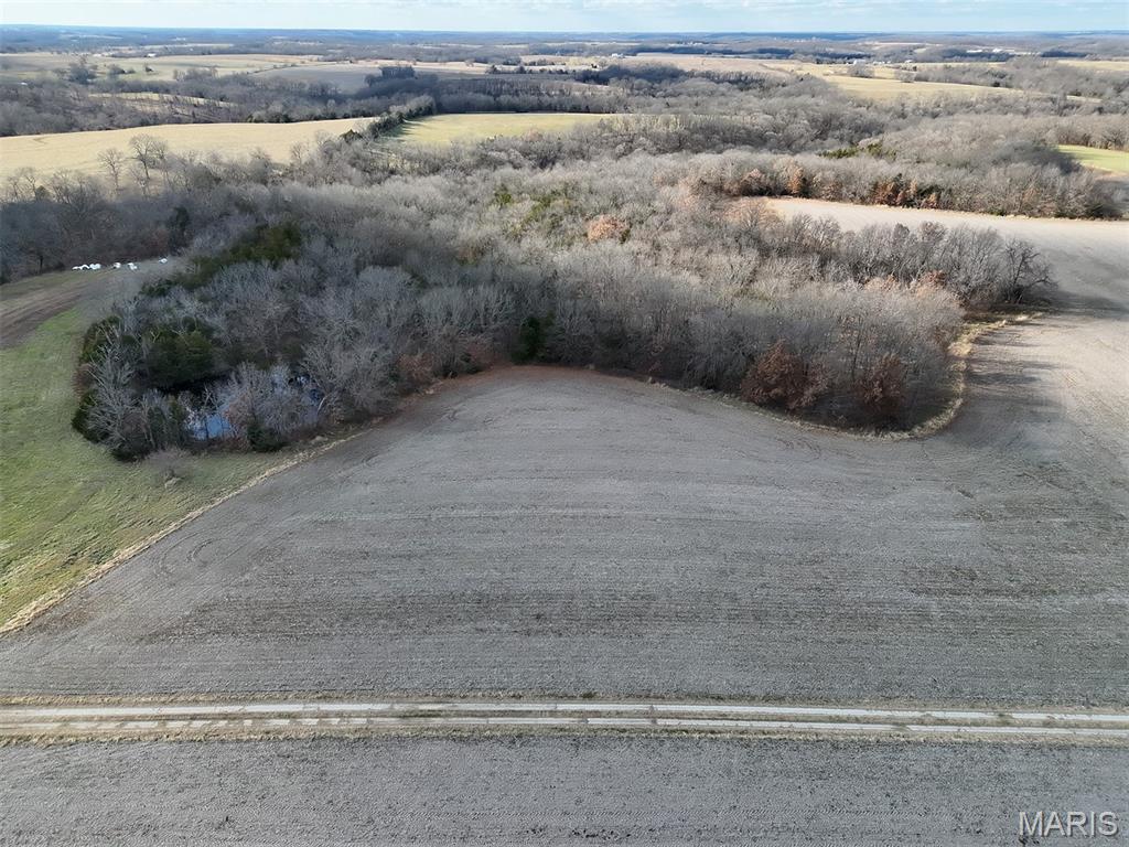 Near Pilot Grove in Cooper County, the property is close to local amenities while offering private rural living.  With 2 acres of land currently in row crop, the remaining land consists of timber with brushy edges, creating good habitat for wildlife. This tract features a small pond and wet weather creek. Perfect tract for hunting or outdoor recreation. The property provides potential build sites for a home. Electric access nearby. Additional unrestricted land is available to expand your land holding. Final acreage subject to survey.