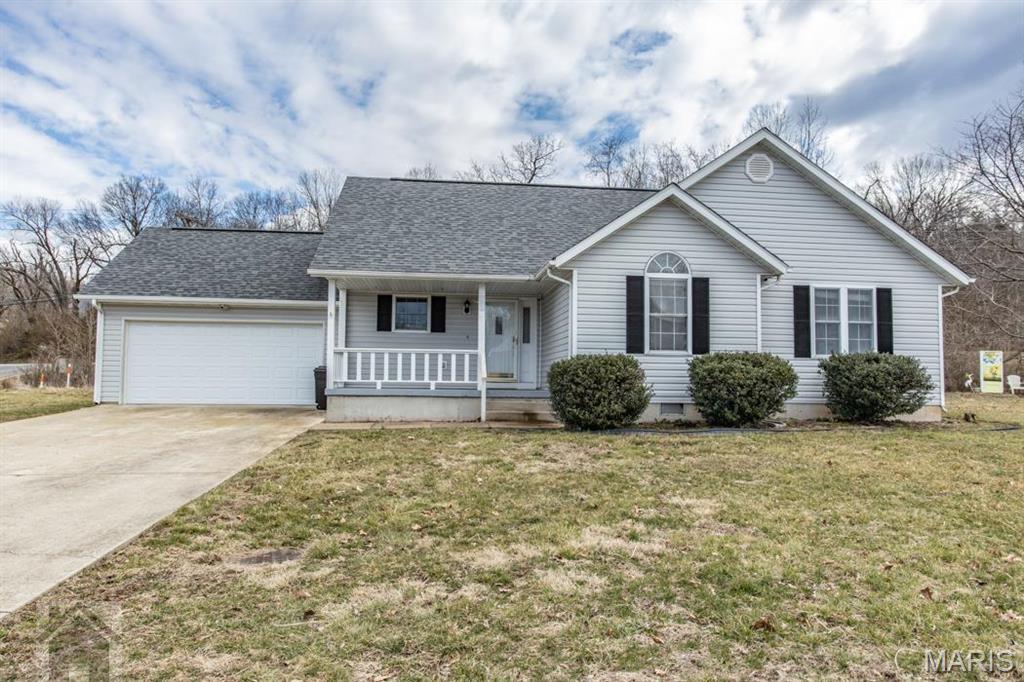 This cute 3 bedroom 2 bathroom ranch style home is located in the Briar Pointe subdivision of west Waynesville and is within minutes to post!  Walk thru the front door into the living area that opens to the kitchen/dining.  Great space for entertaining guests!  The living room has vaulted ceilings, fireplace, and wood floors.  The kitchen has lots of counter space and stainless steel appliances.  The king size primary suite has wood floors, ceiling fan, double vanity and walk in closet.  There are also two additional bedrooms with wood flooring.  This property is located on a double lot (corner lot) and is fenced in.  Other great features include a deck, shed, two car garage, laundry room, and covered front porch!  Call today to schedule your showing!