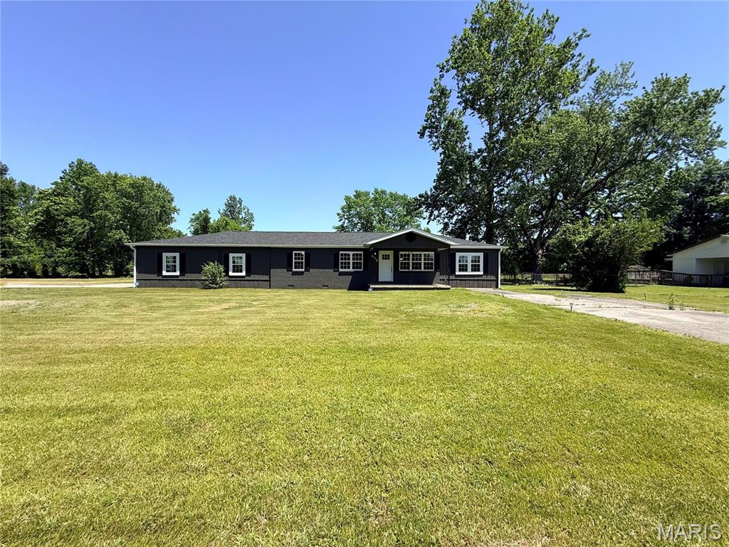 Looking for a turnkey home on .820+/- acres? Welcome to this beautifully remodeled 4-bedroom, 2.5-bathroom residence in Poplar Bluff. Spanning approximately 1,977 square feet, no detail was overlooked during it's renovation in 2024. The interior features custom cabinetry, tile shower, stainless steel appliances, an oversized 2 car garage, new roof and a stunning wood burning fireplace. Enjoy seamless indoor-outdoor living with French doors leading to a private deck. The level yard makes life easy for mowing, gardening, playing and more! Located within the desirable Lake Road School District, this place is a must-see!