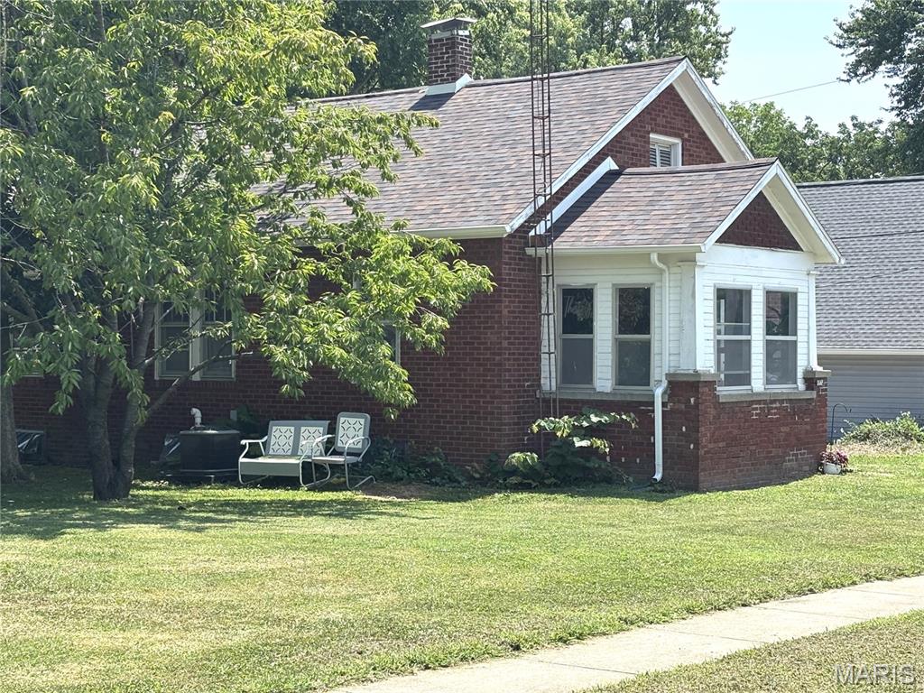 Charming Craftsman on a Double Lot!  Welcome home to this beautifully maintained 3-bedroom, 1.5-bath brick Craftsman situated on a spacious double corner lot in a desirable neighborhood. Just minutes from downtown shopping, dining, and the University, this home offers the perfect blend of timeless character and modern updates.   Step inside to discover gorgeous original woodwork and classic Craftsman millwork, complemented by beautiful hardwood floors and an updated bathroom. The remodeled kitchen features modern conveniences while preserving the home's historic charm, making it ideal for everyday living and entertaining.  Relax year-round on the inviting enclosed front porch, the perfect place to enjoy your morning coffee or unwind in the evening.  
Outside, the oversized double lot provides plenty of space for gardening, recreation, or future possibilities. A detached garage with convenient alley access, along with the corner lot location, offers excellent accessibility and additional parking options.  This is a rare opportunity to own a home filled with character, craftsmanship, and modern comfort in a location that's hard to beat. Schedule your private showing today!