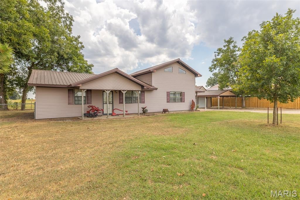 This charming country home offers front yard with a covered porch and a fenced back yard with a covered patio. The one and a half story floor plan is a 4 bedroom and 2 full bathrooms. The living room has a spacious feel with tall ceilings and the dining room is open to the kitchen. It also has a detached garage or shop building.