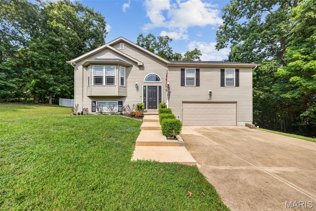 Experience elevated lake-community living in the sought-after Raintree Plantation!  This beautifully maintained home combines timeless style with everyday comfort offering an open concept floor plan that's perfect for entertaining and modern living.  The heart of the home is the large kitchen featuring a center island and designated dining area that adjoins the vast living room creating an ideal space for gathering, cooking, and entertaining with ease.  The main level also features 3 spacious bedrooms including a primary suite with a full bath while the lower-level bonus room offers endless flexibility for a 4th bedroom, home office, media room, playroom, or an additional family room. Outside the attached 26x30 garage is large enough house your vehicles and toys and still have room to work.  The beautiful fenced in backyard is waiting for you to enjoy! Beyond the home enjoy the unmatched lifestyle Raintree Plantation is known for.  Just 3 minutes from the beach, swimming pool, clubhouse with restaurant, tennis courts, and golf course you'll have resort style amenities at your fingertips.  Whether your spending a day on the lake, enjoying dinner with friends, playing a round of golf, or relaxing by the pool everyday feels like a getaway.  Offering the perfect balance of luxury, versatility, and value, this exceptional home is an incredible opportunity to enjoy one of the areas most premier communities.  Don't miss the chance to make this lifestyle your own!
