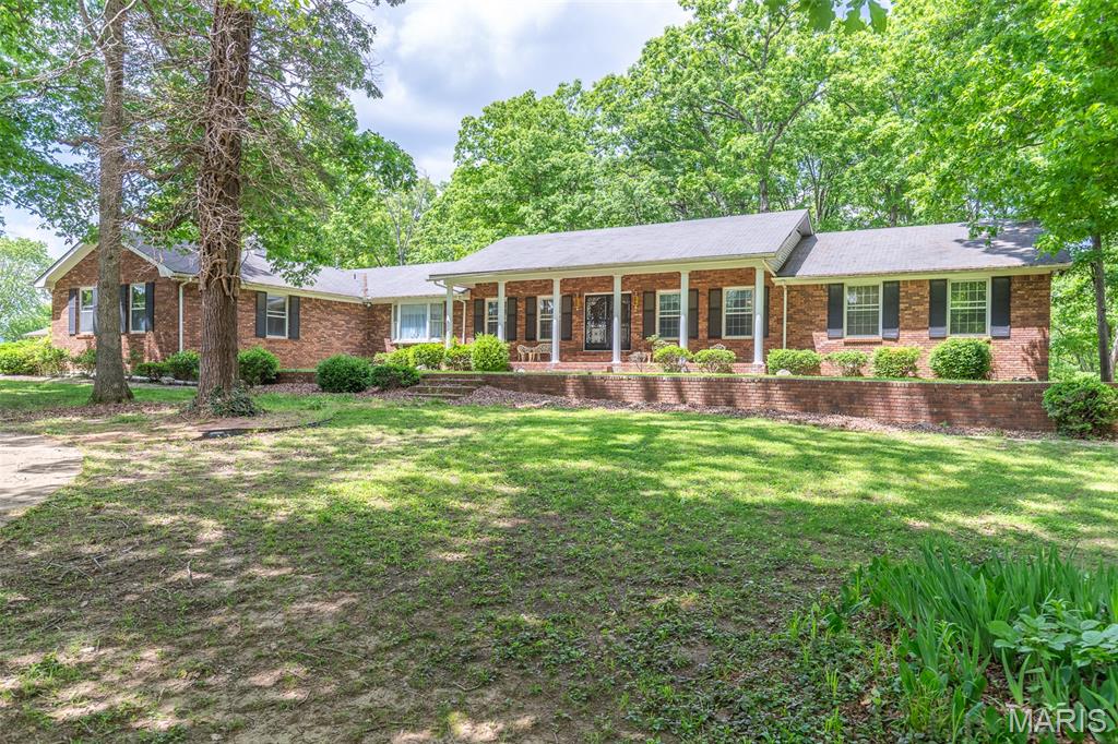 This is one of the most impressive homes in Doniphan! It's HUGE and sits on THREE ACRES +/- in the city limits at the far corner of Sunny Acres. This beautiful, 6280 square foot brick home features a circle drive in front, driveway with garage on the side. And in the back, you'll find a carport, RV storage, workshop, and lawn equipment shed. Inside, there is a huge kitchen, dining room, office, living room, with 3 bedrooms upstairs (2 of them are huge) and 2 full baths. Downstairs is an extremely large open area with another bedroom and bath and another kitchen! Fireplaces upstairs and down. The in-ground pool has not been used in years but could be the life of the party again. (No estimates have been done for repairs and reopening.) Take a minute to calculate what it would cost today to build a home this size (and this quality) on a nice liot this size and you will realize what a great deal this really is. If you've admired it for years, do not let someone else grab it. It is listed at less than $56 per square foot of living space. Compare that with anything else out there.
