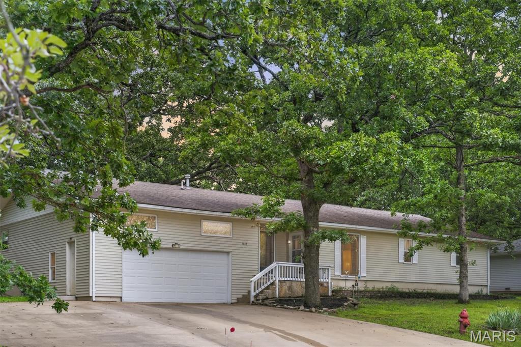 Welcome to lake area living in the heart of Camdenton. This spacious 4-bedroom, 3-bath home offers over 2,000 square feet of comfortable living space with updated finishes and plenty of room to spread out. The functional floor plan features a spacious living area filled with natural light, a well-appointed kitchen complete with a gas range, ample cabinetry, and generous counter space for cooking and entertaining. A standout feature of the home is the presence of two primary suites, offering flexibility for guests, multi-generational living, or added privacy. Outside, you'll find a fenced backyard with mature trees and room to relax, entertain, or enjoy time with pets. The attached 2-car garage provides additional storage and convenience. Located near shopping, dining, schools, and everyday amenities, this move-in-ready home offers the space, functionality, and versatility today's buyers are looking for. Whether you're searching for your first home, room for a growing family, or a property with flexible living arrangements, this one is worth a closer look.