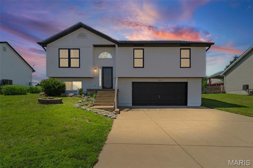This beautiful split-foyer home in the Festus School district offers a clean, modern look with its insulated board-and-batten siding and welcoming curb appeal.  Other updates include a new roof in 2024, new gutters/downspouts, new front window and screens, and a new storm door. Inside you will find 4 bedrooms, 3 full baths with 1232 sq. ft of living space.  Vaulted ceilings and a true open floor plan make the kitchen, living room, and dining room feel like one bright, connected space.  The kitchen features stainless steel appliances, plenty of cabinets, and generous counter space for cooking, prepping, and entertaining. Just off of the main living area, the backyard offers something for everybody--enjoy fun in the sun in the 4 ft. swimming pool and swing set or relax on the oversized patio next to a coy pond that could easily be brought back to life. The lower level adds even more versatility with a second family room, an additional bedroom, a full bath, and a dedicated laundry room. From there, you can walk directly into the oversized two-car garage, offering ample room for parking, storage, or a workshop setup. With its modern updates, open layout, and great outdoor amenities, this home delivers exceptional value in a highly sought-after neighborhood. Just minutes from Larry G. Crites Memorial Park that offers several playground areas, walking trails, a new splash pad, ballfields, and community events/festivals. 
This home offers the perfect combination of living space for the whole family and outdoor enjoyment. Don't miss the opportunity to schedule your private showing today!