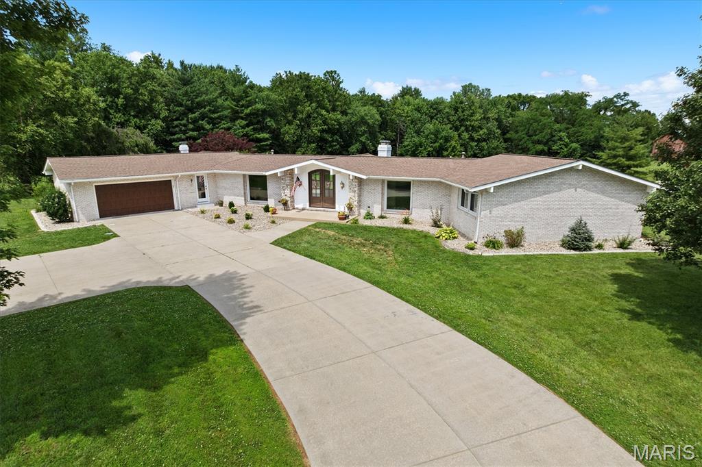 ALL BRICK Mid Century Modern Beauty sitting on 2.76 acres w/gorgeous in-ground pool! This sprawling ranch offers open floor plan, high ceilings, 3 natural stone FP's &  light filled living space! Enter through double arched doors to experience floor to ceiling panoramic views of property w/distant tree line offering just the right amount of privacy. Formal DR & FR access new wrap around low maintenance deck replaced in '24,  leading to salt water pool w/new liner-- awaiting you for those hot summer days! Kitchen w/breakfast bar, newer appl '23, wall of built-in cabinetry, open to FR & view of pool. Finished walk-out LL features rec room, sliders leading to lower patio, addl BR's, huge storage rm & utility rm w/ exterior door, 3rd oversized garage bay w/overhead door. New Carpet on the Main Level, stairs and Rec Room in the LL. Call today!