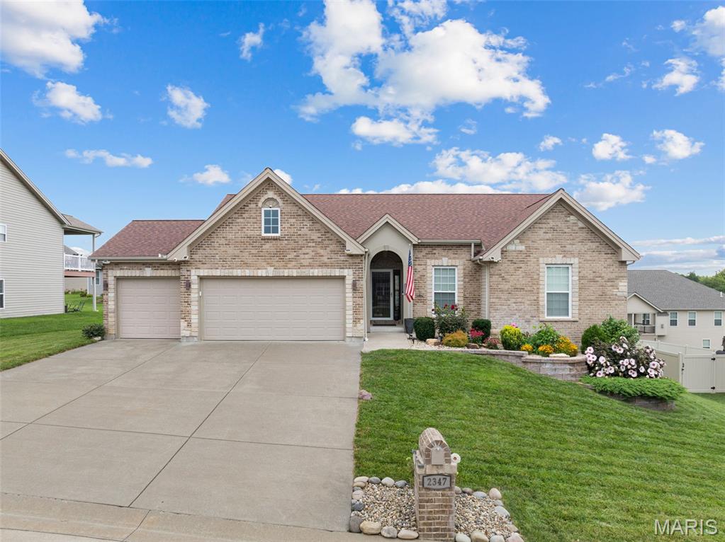 Nestled in one of Washington's most desirable neighborhoods, this beautifully appointed home offers the perfect blend of peaceful living and everyday convenience. Enjoy an established community centered around a beautiful 8-acre lake and scenic streets ideal for evening walks. Beautifully appointed Northern Star-built home in the highly desirable Stone Crest subdivision, where quality craftsmanship meets thoughtful upgraded design. Featuring a sought-after divided bedroom floor plan, this home offers privacy, functionality, and stylish finishes throughout.  Inviting foyer welcomes you into the vaulted open-concept living area is filled with natural light and showcases a cozy gas fireplace flanked by classic divided-light 72" windows. Hardwood floors throughout the main living area provide an inviting yet upscale feel. The impressive kitchen is designed for both everyday living and entertaining, featuring stunning granite countertops, a large center island with both abundant storage and seating, soft-close cabinetry and drawers, custom backsplash, walk-in pantry, stainless steel appliances, and an inviting dining area with access to the spacious covered composite deck. 

The spacious primary suite offers privacy with a luxurious retreat with dual hard surface vanities , a soaking tub, separate walk-in shower, and generous walk-in closet. Second and third bedrooms on opposite side of home both feature 72" decorative cross grille windows for natural light. Secondary bathroom features hard surface vanity top, and large format ceramic tile floors provide durability and a cohesive upscale feeling.  A well designed main floor laundry room featuring run of 42" upper cabinetry providing exceptional storage, complimented by a built-in base cabinet with hard surface countertop makes laundry an ease!  

The walk-out lower level is ready for your finishing touches and already includes a completed bonus room ideal for a home office, hobby room, fitness space, or additional storage. Put your finishing touches on making this exceptional canvas your own design complete with bathroom rough-in for future expansion!

Outside, enjoy the covered composite deck overlooking the backyard, lush established landscaping enhanced by an automatic irrigation system, and the convenience of an oversized three-car garage. Located in one of Washington's premier neighborhoods with scenic surroundings and easy access located just minutes from shopping, dining, schools, Mercy Hospital, and Historic Downtown Washington.  Stone Crest provides the lifestyle you've been searching for—quiet surroundings without sacrificing convenience.