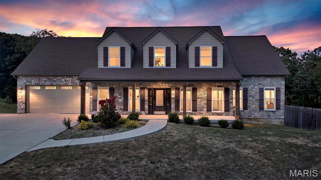 Set on 1.6 acres and built in 2021, this exceptional 1.5-story residence offers more than 4,400 square feet of beautifully finished living space, impressive craftsmanship, and a floor plan designed for both luxury living and effortless entertaining. At the center of the home is a stunning chef’s kitchen appointed with premium cabinetry, elevated countertops, beautiful flooring, designer lighting, a pot filler, and a generous dine-in area. Just steps away, the formal dining room provides the perfect setting for memorable gatherings, while the living room creates a dramatic focal point with striking ceiling detail and a handsome stone gas fireplace. The main-floor primary suite feels like a private retreat, complete with dual closets and a beautifully finished luxury bath. An additional main-level bedroom, spacious half bath, and convenient laundry room add flexibility and ease to the first floor. Upstairs, two additional bedrooms, a large full bath, and an expansive recreation area provide plenty of room for family, guests, or a private lounge. The walkout lower level is equally impressive, featuring a massive entertaining space, full wet bar with dishwasher and mini refrigerator, full bathroom, and an additional bedroom which is ideal for overnight guests, extended living, or a private suite. Outdoor living is just as inviting. A substantial composite deck overlooks the fenced backyard and peaceful wooded backdrop, creating a private setting for relaxing or entertaining. An oversized two-car garage, extra-wide driveway, and thoughtful ADA-friendly features add convenience without sacrificing style. Rich in character and filled with upgrades, this home offers the rare combination of luxury finishes, generous living space, privacy, and versatility; all in a setting that feels both refined and welcoming.