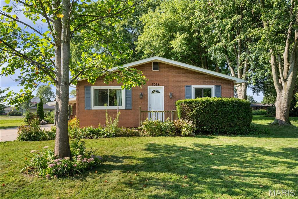 This CHARMING 3 bed, 1 bath ranch home is located in popular Holiday Shores just minutes from downtown Edwardsville. Holiday Shores offers a clubhouse, restaurants, playground, boat dock, fishing & more! New shingles-August 2026! (Not an insurance paid claim.) Walk into the living room which is open to dining area and kitchen which encourages conversations and easy to move on the August 2026 installed luxury vinyl tile. You could be the first to use the new dishwasher-August 2026! There is lovely ceramic detailing in the shower and new marble flooring in the bathroom. You will love the space provided for your stackable washer and dryer. So convenient. There is a very large concrete pad ideal for parking multiple vehicles or playing outdoor sports such as pickleball or basketball. The carport has an attached shed awaiting your garden tools and lawn mower. The backyard includes towering trees and a stunning pergola with mature wisteria forming a beautiful ceiling creating shade so you can relax in your favorite chairs. If you are looking for your first home or perhaps want to downsize, this listing is ideal to consider for the modest price.