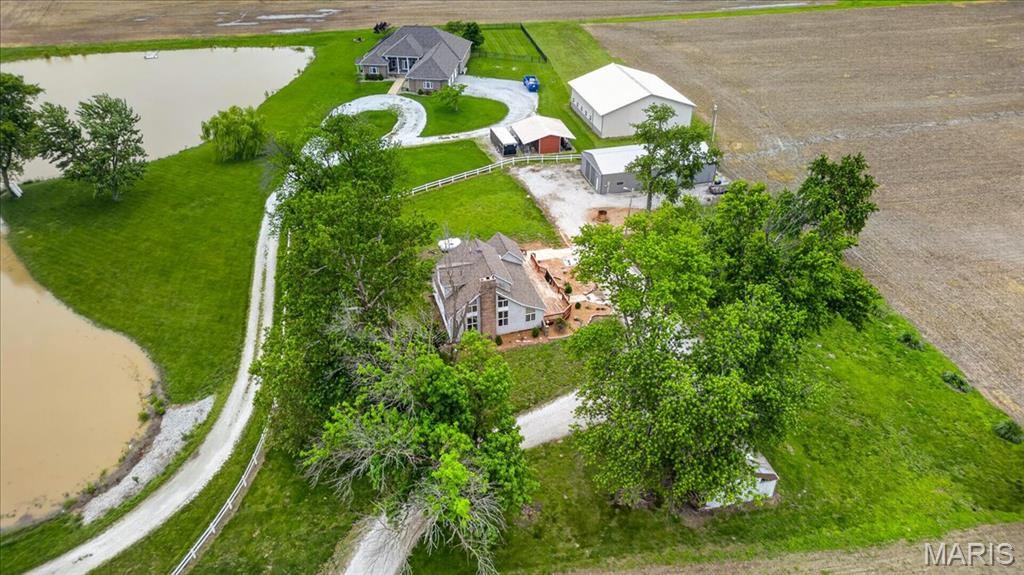 Country living just minutes from everywhere! This well-maintained home sits on approximately 2.71 acres in the highly sought-after Waterloo School District. From the moment you arrive, you’ll fall in love with the expansive deck spanning the length of the home — the perfect place to enjoy your morning coffee or relax while watching the sunset over the surrounding fields.
Inside, you’ll find over 1,800 finished square feet with a thoughtful layout and recent updates throughout. The large foyer entry opens to a formal sitting area, currently used as an office space, that flows into the spacious living room featuring vaulted ceilings, a wood-burning fireplace, and loads of windows that fill the space with natural light.
Just beyond the living room is a large formal dining area located next to the recently updated eat-in kitchen, complete with ample cabinet storage and appliances that stay with the home. A newly remodeled full bath and oversized laundry/storage room complete the main level.
Upstairs, you’ll find the private living quarters featuring 3 comfortable bedrooms and an additional full bath.
Step outside and enjoy the picturesque setting with plenty of room for recreation, gardening, hobbies, or simply soaking up the privacy. The oversized detached garage/outbuilding (30x60) offers exceptional storage and workspace with concrete floors, electric, oversized front access door, additional side entry, and even a pit for working on vehicles.
Additional features include TWO HVAC systems — one dedicated to the upper level and one for the main level — along with a NEW roof installed in 2025.
This unique property offers endless possibilities with the comforts of country living and the convenience of quick access to Route 3 — a rare opportunity you won’t want to miss.
Don’t miss your chance to Live Where You Love!