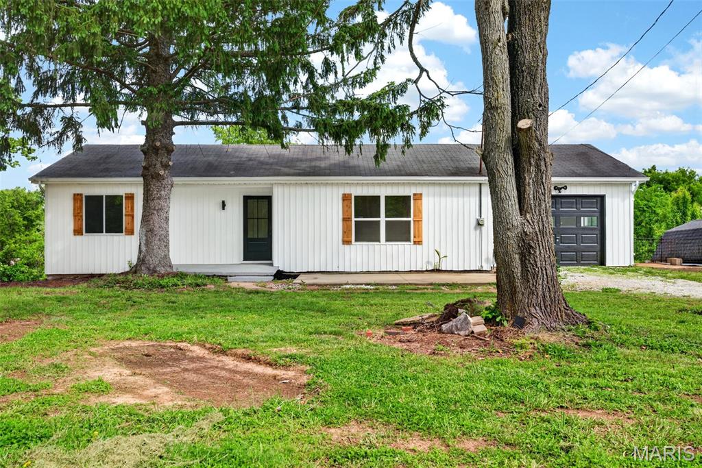 Fully updated ranch on just over an acre with nothing left to do! Updates include new siding, windows, flooring & fresh paint throughout. Remodeled kitchen features new appliances & updated finishes. Spa-like bathroom boasts a double vanity & custom tile work. Main level offers 3 bedrooms & 1 full bath. Finished walkout lower level features a large rec/entertaining area, 2nd full bath & attached 1-car garage. Additional 1-car garage at the front of the home provides extra storage or parking. Enjoy a large, open yard with plenty of room to roam.