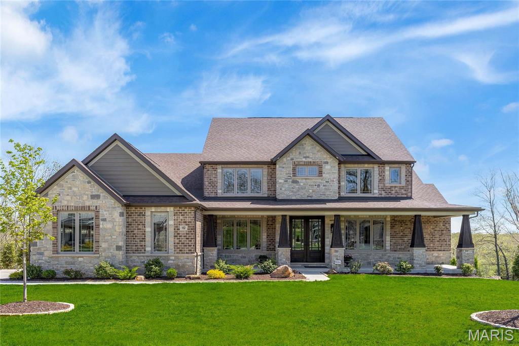 This spectacular 5477 sf brick & stone 1.5 Sty from Lombardo Homes features soaring ceilings, designer lighting & hickory hardwoods that extend throughout the main floor. Impressive hardwood foyer leads to formal dining room with arched entryways and stunning great room with stacked stone fireplace flanked by built-in display cases & dramatic 2-sty wall of windows. Designer kitchen with 42” glazed cabinetry, granite countertops, premium appliances, 7’ center island & butler’s pantry adjoins breakfast room & vaulted sunroom with atrium door to deck. Coffered primary bedroom suite with wide bay window & luxury bath with freestanding tub offers an appealing retreat. The 2nd floor extends the living quarters with 3 additional bedrooms, 1 with ensuite bath & 2 with Jack n’ Jill bath, & bonus room. Lower Level includes expansive recreation room, 5th & 6th bedrooms & full bath. Situated on a .87-acre cul-de-sac lot with wrap-around deck, open patio & covered patio with full-height fireplace. Additional Rooms: Mud Room, Sun Room