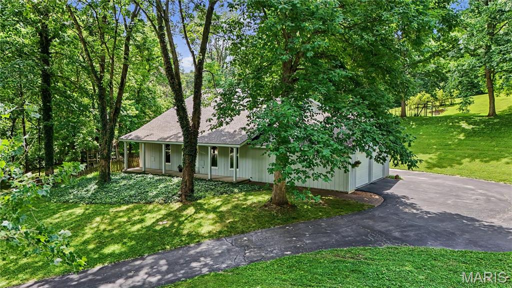 Beautiful park-like property on 3.5 private acres in Hazelwood. One owner, move-in ready, and very well-maintained.  4 bedrooms, 2 full bathrooms and a dry basement.  2 x 6 construction for energy efficiency.  Extra-large attached garage and a two-story 3 season sunroom.  Large, separate, 24' x 36' shop with full drive-in basement.  NEW roof, garage doors, and main service panel.  Heat pump water heater.  Fenced garden area with water faucet.  Established blueberries and perennials.  550' frontage, 200 acres Conservation Department property on back (south) and east side boundaries.