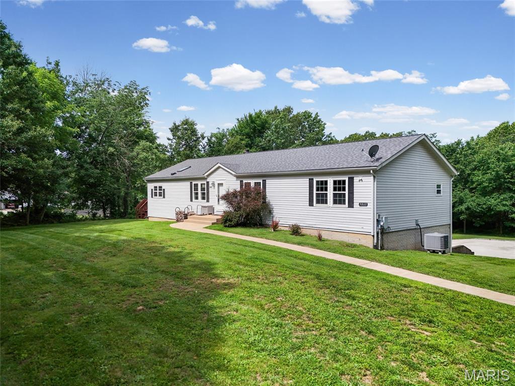 First time on the market! Nestled on nearly 5 unrestricted acres in the Hillsboro School District, this beautifully updated 3-bedroom, 2-bath home offers the perfect blend of privacy, comfort, and functionality. Enjoy abundant wildlife year-round with frequent deer and turkey sightings right from your backyard.The open floor plan features luxury vinyl flooring throughout the main living areas, a cozy wood-burning fireplace in the great room, and a charming sitting area. The updated kitchen boasts refinished cabinetry, center island, new countertops, stylish backsplash, and all appliances are included—even the washer and dryer.Glass doors lead to a spacious 16x20 deck, ideal for outdoor entertaining and enjoying the peaceful country setting. The primary suite offers a large walk-in closet and a spa-like bath featuring a new shower enclosure and oversized soaking tub. Main floor laundry adds convenience, while the recently updated guest bath and fresh paint throughout make this home truly move-in ready. The finished walk-out lower level provides additional living space with a large recreation area, sleeping area, bonus room, professional-grade treadmill, and ample storage. The full walk-out basement also includes a 2-car tuck-under garage.Additional updates include HVAC, water heater, water softener, windows, interior doors, and baseboards. Outside, you'll find a 12x16 lofted outbuilding and plenty of room to add a pole barn, detached garage, or additional outbuildings. A rare opportunity to own unrestricted acreage with modern updates and room to grow. Must see to appreciate—all that's left to do is unpack!