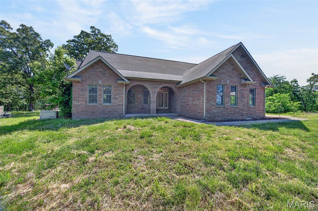 This breathtaking property is a private oasis with almost a mile of river frontage, views, two stocked ponds, 117.40+/- acres, and a stunning home! The home itself includes two, possibly three bedrooms on the main level, two and a half bathrooms, formal dining area, and main living area featuring natural light that sets an ambiance for everyone that gathers together. The kitchen hosts a breakfast bar, granite countertops, and pantry. The attached garage connects to the laundry room/mud room which leads down into the partially finished basement that hosts another living area and another non-conforming fourth bedroom or office opportunity. With a little bit of ingenuity the walkout basement could become a separate living area or mother in law suite for those visitors that will be choosing your home for those holiday gatherings. All kitchen appliances, washer and dryer, and remaining furniture within the home will stay as well. As you go outside, you are beckoned onto the composite back deck to enjoy the views and take in your surroundings. There is also a 12x40 shop, 40x60 lean-to, and outbuilding for storage, hobbies, and equipment. Head down to your river access with almost a mile of river frontage for family fun or take a stroll to your two stocked ponds and make memories that will last a lifetime. This residence is also a short hour  drive away from the Lake of the Ozarks as well! This property offers a legacy for a family that will continue for generations. Your journey begins here, what are you waiting for?