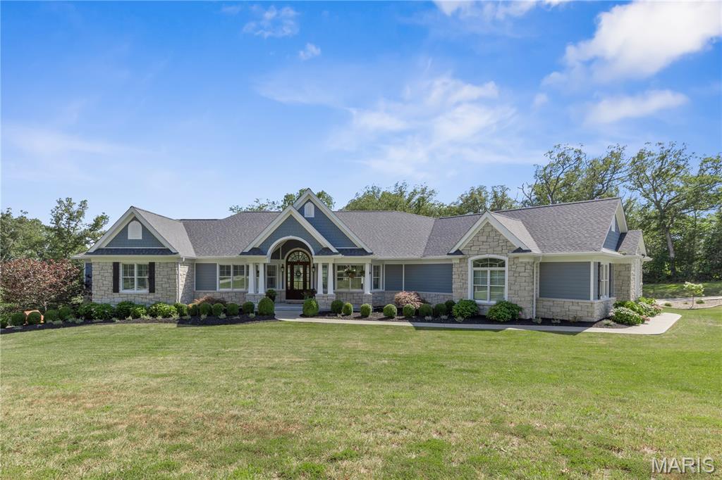 Step into timeless elegance & unmatched craftsmanship in this luxury home overlooking a serene wooded valley within the award-winning Francis Howell Schools. Boasting 5 bedrooms, office, 3 full baths & 2 half baths, this home was designed for refined living & effortless entertaining. The open-concept floorplan features vaulted ceilings, 8-foot doors, crown molding, built-in bookcases & rich hardwood floors. The gourmet kitchen showcases custom Amish-built cabinetry with pullout mixer stand & drawer organizers, Thermador appliances—including a 6-burner gas cooktop with griddle, double convection ovens with rotisserie, built-in fridge, industrial vented hood, Brizo faucet, under-cabinet lighting & walk-in pantry with a 2nd fridge. Built-in speakers in the kitchen & lower level create the perfect ambiance. Enjoy the formal dining room, breakfast room & hearth room with gas fireplace. The luxurious primary suite features a tray ceiling, dual walk-in closets with organizers, & a spa-like ensuite with clawfoot tub & walk-in shower. The finished walkout lower level offers 2 bedrooms, a full bath & half bath with Hansgrohe fixtures, theater area, sound-insulated music room with upgraded outlets, exercise room & full bar—ideal for entertaining or multigenerational living. Relax on the large cedar deck overlooking a wildflower-filled wooded valley. With an oversized 3-car garage, Geothermal HVAC & new roof & gutters, this home is the perfect blend of luxury & efficiency. (Agent owner)