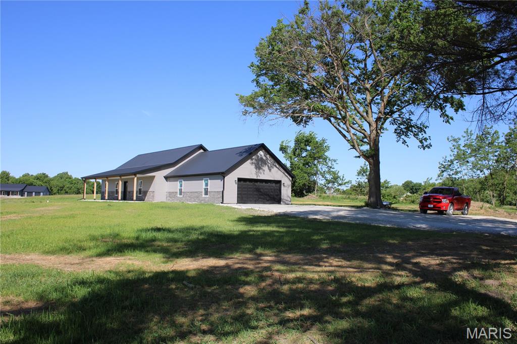 Three bed, two bath home with a two car attached garage sitting on 3.12 surveyed acres located just south west of Hannibal, MO. Open floor plan design with a large living room area. Hickory kitchen cabinets with granite countertops. Master bedroom comes with a full bathroom and a walk-in closet. There is a 24x36 machine shed with concrete floors on the property as well!