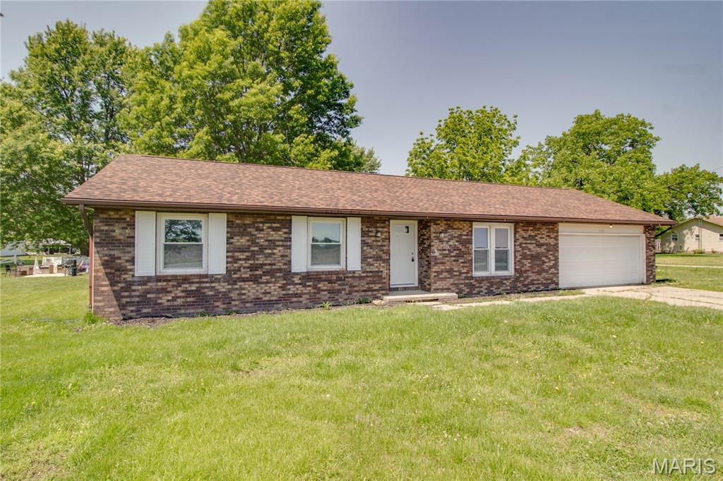 Priced below appraised value!! Move right in to this beautifully updated brick-front ranch! It offers a bright, open layout and modern finishes throughout. From the moment you arrive, you’ll appreciate the concrete driveway and attached 2-car garage with additional workshop space. Enjoy low maintenance with the brand new roof and vinyl siding. Inside, the spacious living room flows seamlessly into the kitchen and dining area, creating an ideal setup for everyday living and entertaining. Stylish vinyl plank flooring runs throughout the main living spaces, while the kitchen features white cabinetry, an electric stove, dishwasher, and plenty of counter space for meal prep and gatherings. The sliding glass door off the dining area invites in natural light and provide easy access to the concrete patio and fenced backyard, providing the ideal setting for outdoor dining, relaxing, or hosting guests. The main floor also includes a convenient laundry/mudroom with direct access to the garage and backyard. The primary bedroom offers its own private 3/4 bath, while two additional bedrooms and a full hall bathroom provide flexibility for guests, hobbies, or home office space. This home tastefully combines comfort, functionality, and easy living all in one package. Property has been recently appraised for your convenience!