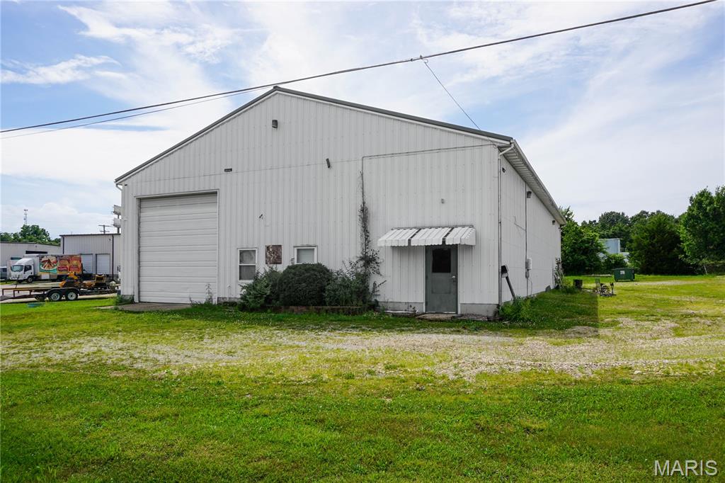 Versatile Shop Building with Office Space in an Established Industrial Area! This well-equipped commercial property offers approximately 4,000 SF M/L of shop and office space with endless possibilities for industrial, warehouse, contractor, manufacturing, or service-related uses. The front office features central heat and air, a reception/work area, one restroom, and an additional upstairs office. The insulated shop area includes a parts room, floor drains, 400-amp electrical service, one electric heater, and impressive 16-foot eave height. Two 12' x 14' overhead doors provide excellent access for large equipment, trucks, or inventory. The building is constructed with durable metal siding and a metal roof and is served by county water and sewer along with Intercounty Electric. Located in an established industrial area, this property is ready to support a wide range of business operations.
