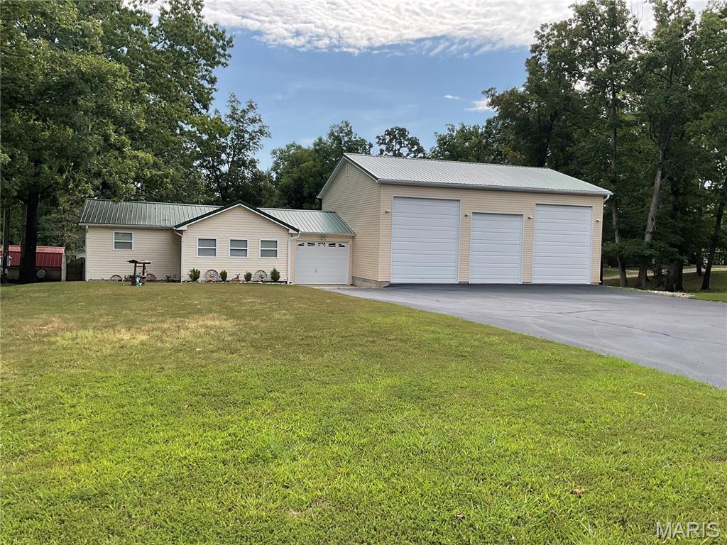 Great investment opportunity near Lake Wappapello! This 4-bedroom, 2-bath home offers plenty of space and comes with the contents included, making it an easy option for a lake getaway, rental, or full-time residence. Enjoy relaxing on the screened-in porch, while the large garage provides excellent storage for a boat and other lake toys. A newly completed driveway offers plenty of parking for guests. Conveniently located close to the lake, this property has tons of potential and is ready for its next owner!