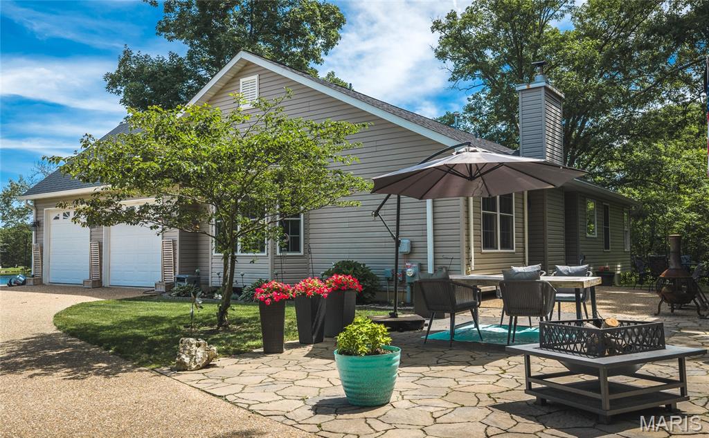 Imagine waking up to enjoy the perfect blend of lakefront living and country privacy and still being just minutes to Interstate 70 & Hwy 47. This beautifully maintained home offers peaceful surroundings while still being just minutes from major routes.
Step inside to discover thoughtfully updated bathrooms and a well-appointed kitchen with modern charm, ideal for everyday living and gatherings together. The cozy living room with a wood-burning fireplace creates a warm, inviting atmosphere to relax and unwind.
The spacious primary suite boasts a walk-in closet and a stunning ensuite complete with a freestanding soaking tub, double vanity, and oversized walk-in shower, all finished with quality Delta Faucet fixtures.
Wake up to beautiful lake views from two additional main-level bedrooms, offering both comfort and scenic charm.
The lower level expands your living space with an expansive family area built for entertaining—complete with upgraded insulation, memory foam carpet, and the ideal setup for a home theater experience; designed to help minimize sound transfer so movie nights stay immersive without carrying upstairs.
If you’re looking for privacy, comfort, and picturesque lakefront views without sacrificing accessibility, this property delivers it all.