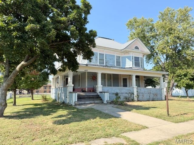 Historic Victorian Home with Endless Potential
Step back in time with this charming 3-Story Victorian home, built in 1880 and filled with character and possibilities.  This spacious property offers a welcoming entryway, formal dining room, separate kitchen and a large living room featuring beautiful wood floors.  The wrap-around front porch adds timeless curb appeal and provides the perfect spot to relax and enjoy the outdoors.
The home offers a main-level laundry area and a bathroom addition at the back of the house.  An exterior entrance provides convenient access to the basement.  The metal roof was installed approx. 2013, and furnace/AC with heat pump were replaced in 2011.  
A standout feature is the 3-car detached garage, offering plenty of space for vehicles, storage, hobbies, or a workshop.
The upper level includes separate living quarters, complete with full kitchen, dining area and family room-an ideal setup for extended family, guests, rental potential or additional living space.
This historic home needs some TLC and is ready for someone to bring their vision and restore its character.  With its original charm, generous living spaces, detached garage, upstairs living quarters, this property offers a unique opportunity to own a piece of history and make it your own.