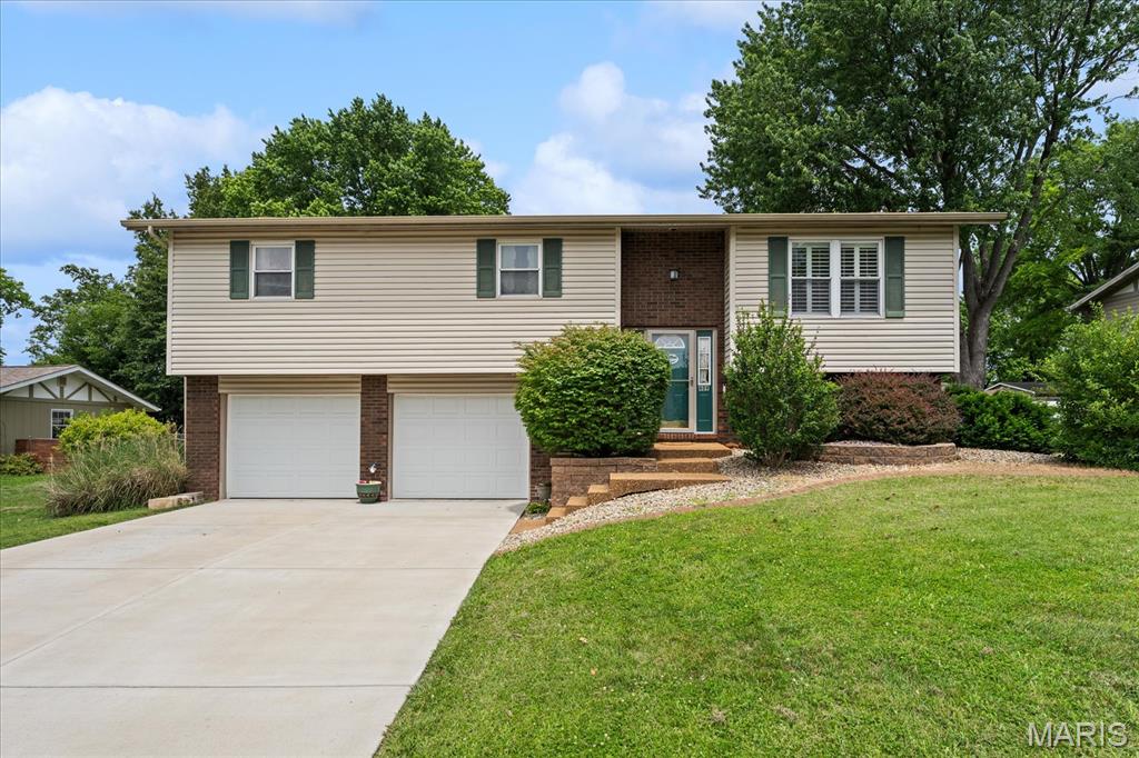 Guess what? We've got a 4 bedroom/3-bathroom home in quiet and established neighbor in Collinsville! Welcome to 409 Chapel Drive! Enter the foyer and check out the large living room space which opens to separate dining area and kitchen. Easy access to the backyard, deck and patio furniture (will stay). The kitchen has desirable central island, ample cabinets and countertop space, and room for additional buffet or cabinet! All appliances WILL stay! 3 bedrooms are located on the main level with spare hallway bathroom and a primary bedroom and desired en-suite with stand-up shower. Lower level offers additional bedroom, half bathroom and recreation room. Convenient stackable washer and dryer will stay! 2 car garage with interior and exterior access doors. Updates/Systems: HVAC (2017), Roof (2019), Deck (2020), Garage Doors (2023), Bathroom floors and vanities (2021), Bedroom floors (2025) and Driveway (2025). A lovely home, lovely neighborhood and beautiful fenced backyard with storage shed with raised gardens ready for your imagination! Add this one to the list!