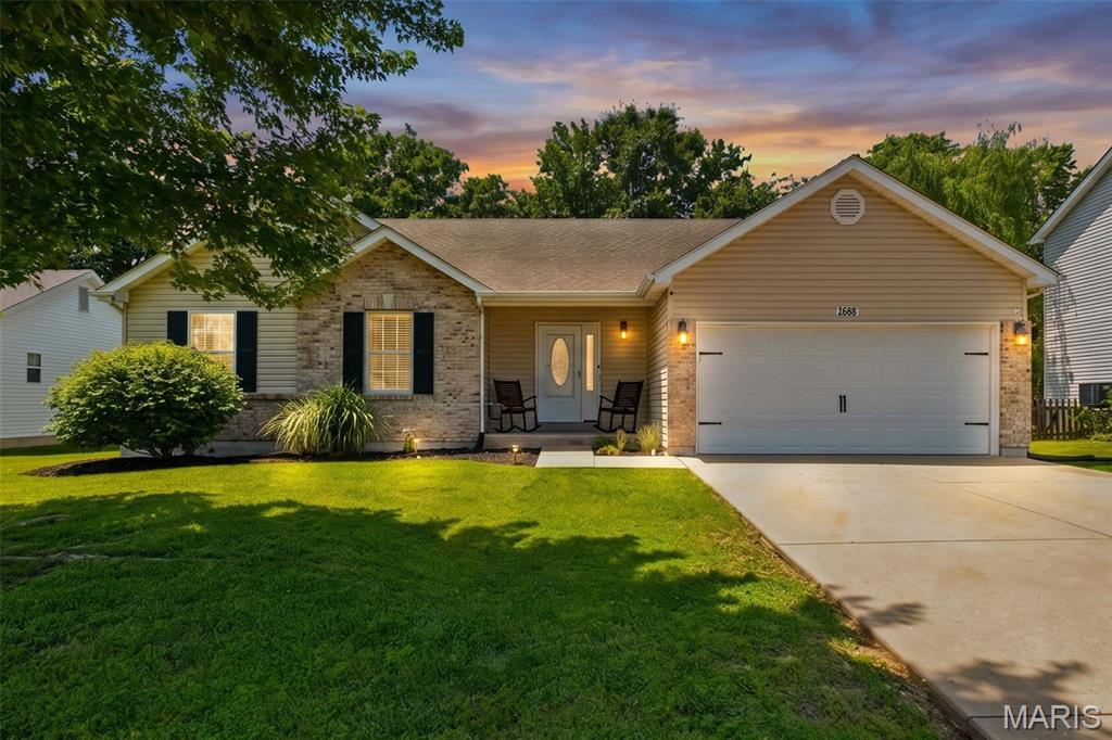 Welcome to this beautifully maintained ranch home in sought-after Warren County, ideally located just minutes from Interstate 70 and conveniently positioned between St. Louis and Columbia. This spacious 3-bedroom, 2-bath home offers over 1,450 square feet of comfortable living space with a modern, open floor plan designed for both everyday living and entertaining. The inviting entry foyer leads into a vaulted great room filled with natural light, creating an airy and welcoming atmosphere. The kitchen features staggered cherry cabinetry, ample counter space, and includes appliances, making it both functional and stylish. A main floor laundry room adds everyday convenience. The vaulted primary suite is a true retreat, offering a large bedroom, walk-in closet, and private bath. Two additional generously sized bedrooms provide flexibility for family, guests, or a home office. Step outside to enjoy a level lot with patio that backs to trees, offering added privacy and a peaceful setting. Additional features include a 2-car garage and location within the Warrenton School District. This home combines space, comfort, and a prime location.