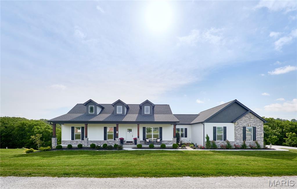 Why wait to build? This nearly new home on 2 private acres offers modern finishes, thoughtful upgrades, and room to grow. The open-concept floor plan is filled with natural light and features a beautifully appointed kitchen with quartz countertops, a large center island, 42" shaker-style cabinets with crown molding, soft-close doors and drawers, black stainless appliances, and an oversized walk-in pantry. Refrigerator, washer, and dryer are included. Step outside onto the Wolf composite deck and enjoy peaceful views of the surrounding countryside. The professionally landscaped lot also features an expanded patio with fire pit, creating the perfect setting for relaxing or entertaining. The spacious primary suite offers a walk-in closet and a luxurious bath with a custom marble walk-in shower, rain head, and transom window. Two additional bedrooms, a full bath, dedicated laundry room, and a fantastic mudroom with built-in storage complete the main level. The walkout lower level is ready for your vision with three egress windows, rough-in plumbing for a future bath, a large concrete safe room, and ample space for additional living areas. A rare bonus: approved detached outbuildings and workshops are allowed, giving you the flexibility to add extra garage space, storage, or the workshop you've always wanted. Additional features include luxury vinyl plank flooring, custom trim and doors, Hunter Douglas blinds, window tinting, a high-end water softener, and an oversized insulated and drywalled 3-car garage. Enjoy the benefits of new construction without the wait!