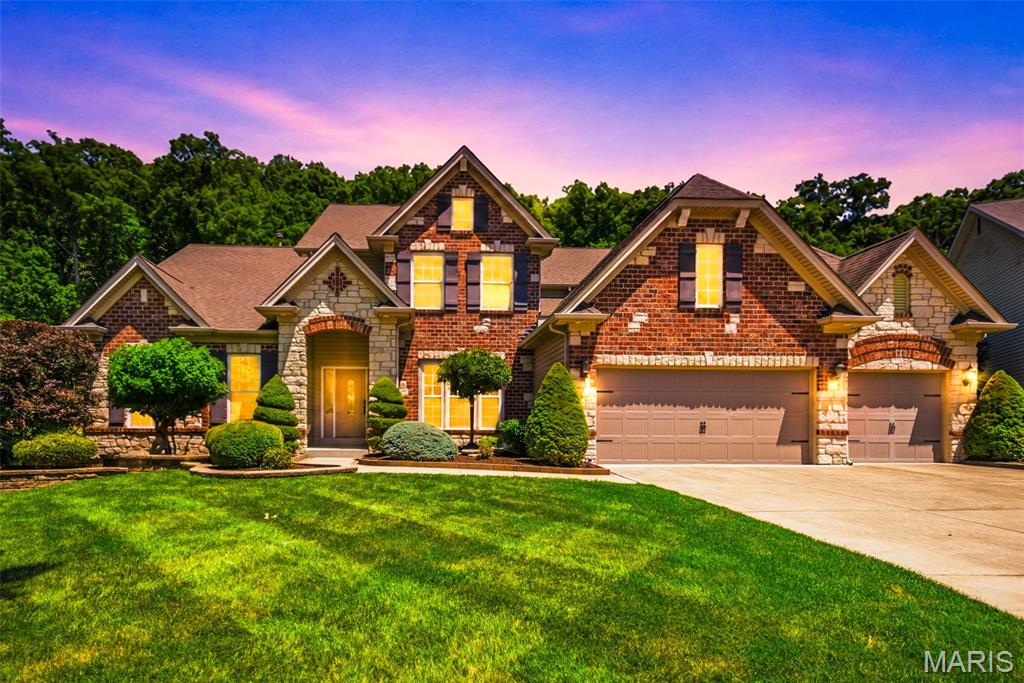 Welcome to this stunning custom built 1.5 story home offering nearly 5,400 square feet of luxury living space on a private 1.01 acre lot backing to trees. This impressive 6 bedroom, 4.5 bath home features an open floor plan with engineered wood flooring throughout the main level common areas, a private office, formal dining room with coffered ceiling, and a spacious great room with a wall of windows. The gourmet kitchen boasts 42” cabinets with crown molding, granite countertops, tile back splash, oversized center island with breakfast bar, stainless steel appliances, double wall oven, and a walk in pantry. The breakfast room with coffee bar opens to the hearth room which has a vaulted ceiling, gas fireplace with stone surround and access to the large concrete patio. The luxurious main floor primary suite offers a coffered ceiling, walk in closet, and spa like bath with double vanities, custom tile shower, jetted soaking tub, and private water closet. A laundry room with built in cabinetry and sink, drop zone with boot bench and cubbies, and half bath complete the main level. Upstairs features a large loft, 3 bedrooms with walk in closets, and 2 full baths. The finished lower level adds 2 additional bedrooms, a full bath, family room, recreation room, and wet bar. Enjoy the peaceful wooded setting along with community amenities including an inground pool, walking trails, and pickleball courts. This exceptional custom home offers the perfect blend of luxury, space, and comfort.