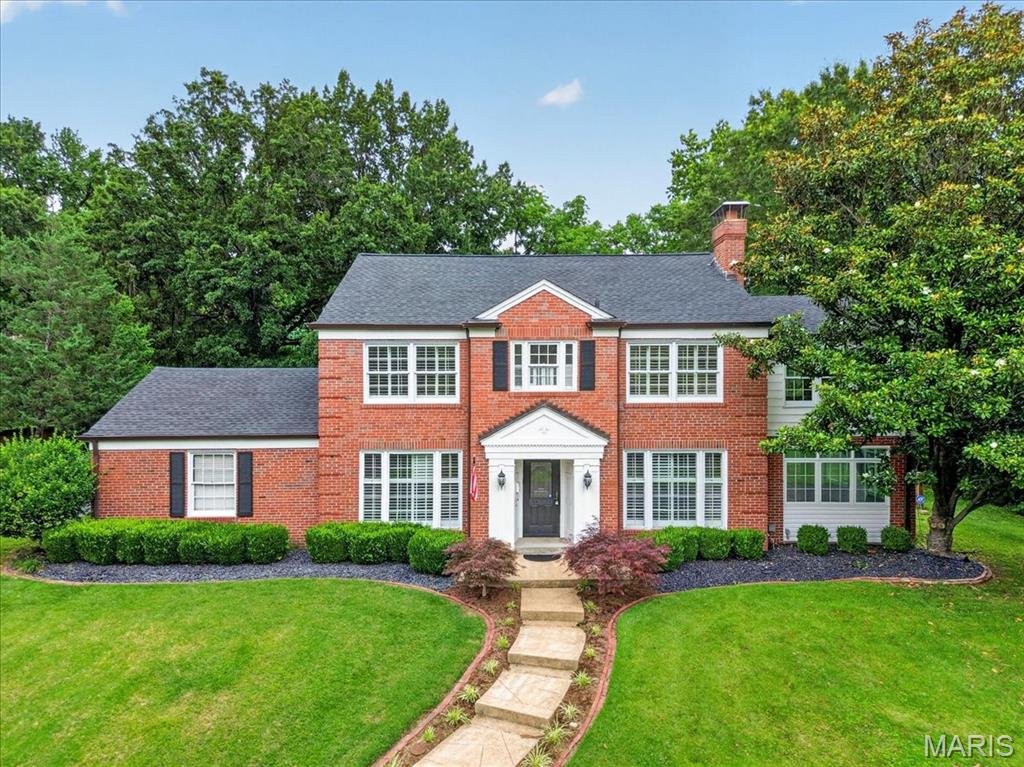 Welcome home to this stunning two-story residence in the highly sought-after Ladue School District, situated on a private lot with a spectacular inground gunite pool. Inside you are greeted with high-end finishes throughout, including hardwood floors, tall baseboards, wainscoting, updated lighting, and elegant architectural details. The welcoming entry foyer is flanked by a formal dining room and a formal living room featuring a fireplace, which flows into a sun-filled office/sunroom. Designed for both everyday living and entertaining, the spacious family room boasts a vaulted ceiling, fireplace, and expansive windows overlooking the backyard pool oasis. The chef’s kitchen is equipped with granite countertops, a gas range, center island, ceramic tile flooring, and a breakfast room. Upstairs, the primary suite offers two closets, a wood-paneled sunroom, and an en-suite bathroom with access to the second bedroom. Two additional bedrooms and a full bathroom complete the second level. A unique third-floor bonus space provides two vaulted living areas, perfect for a playroom, home office, or media room. The finished lower level adds more than 1,000 square feet of living space and includes a large recreation room with a built-in entertainment center, wet bar, full bathroom, and laundry room. The backyard retreat is truly exceptional, featuring a fenced gunite pool with a tanning ledge, waterfall, diving board, and built-in hot tub. Beyond the fence line, the property extends further, offering additional green space and privacy. This one-of-a-kind home combines luxury, functionality, and resort-style outdoor living in an unbeatable location in the Berkshire neighborhood.
