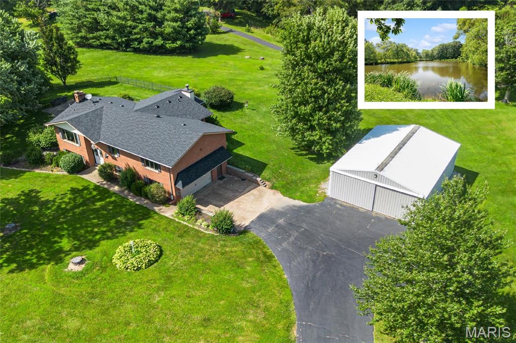 Are you searching for O'Fallon Township High School homes for sale with acreage, or a quick commute to Scott Air Force Base? This premier 5.7+/- acre estate right in the heart of O'Fallon, IL is the listing you have been looking for!

This rare property features a massive, detached 45x30 outbuilding—ideal for a premium workshop, hobby space, boat storage, or home business. Outdoor enthusiasts will love the private lake access, perfect for fishing and paddleboating, as well as the oversized, maintenance-free deck (updated in 2022) leading down to a fully fenced backyard. The home also features an attached storage room under the extended hearth and master bath. 

The wonderfully updated home boasts 4 spacious bedrooms, 3 full bathrooms, and a stunning kitchen extension. This open design features a cozy hearth room that serves as the true nucleus of the home. Retreat to the main-floor Master suite, which features an expanded, luxury Master bathroom nearly tripled in size to include a double vanity, large soaking tub, and separate shower.

The fully lower level area adds incredible living space with a large family / rec room, a spacious 4th bedroom, a full bathroom, and an oversized laundry room equipped with a custom drop zone and garage access.

Located just minutes from downtown O'Fallon, Scott Air Force Base, local schools, parks, shopping, restaurants, and downtown St. Louis. Acreage with this level of convenience does not last long—schedule your private showing today!