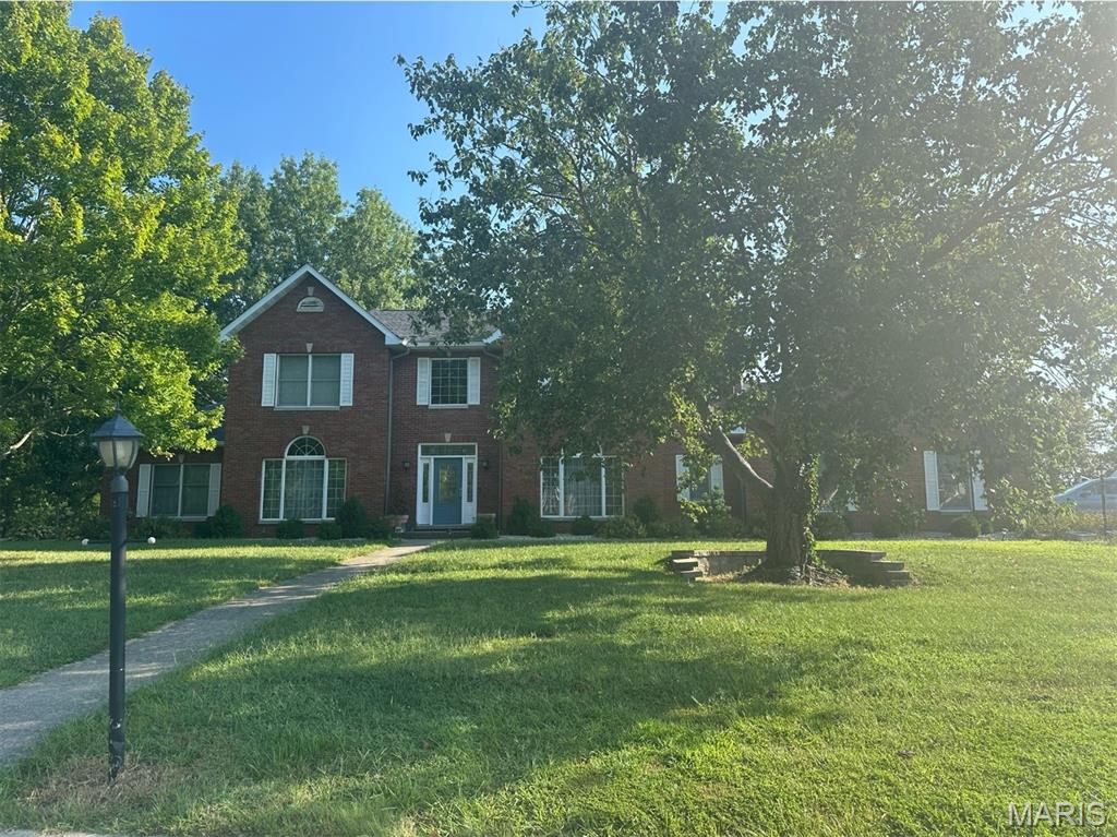 A rare opportunity like this doesn’t come along often. Set on an impressive 1.7 acres including a pond - 116 Fairwood Hills Road offers the perfect blend of space, comfort, and peaceful living in the heart of O’Fallon. From the moment you arrive, this home invites you to relax, entertain, and enjoy life at a slower, more intentional pace.
With three floors of living space, the home features 5 bedrooms and 4.5 bathrooms, providing flexibility for families, guests, and work-from-home needs. The expansive kitchen and dining area anchor the main level, creating a natural gathering place for everyday meals and special occasions alike, while the main-floor laundry adds everyday convenience. Cozy up by the fireplace on the main level or the custom wood-burning fireplace on the lower level, ideal for movie nights or entertaining guests.
Car enthusiasts and hobbyists will appreciate the three-car garage on the main level, along with an additional lower-level garage that is ideal for a workshop or storing lawn equipment. Outside, the backyard oasis with its serene pond backdrop is perfect for unwinding or entertaining. Major 2025 updates include a new impact-resistant shingle roof, new siding, and a new main-level HVAC system - adding lasting value and confidence.
Thoughtful upgrades include a whole-house vacuum system and a transferable Barcom security contract for added peace of mind.
Experience this exceptional property for yourself.  Schedule your private showing today. 
Taxes and Lot Acres reflect total for both parcels.