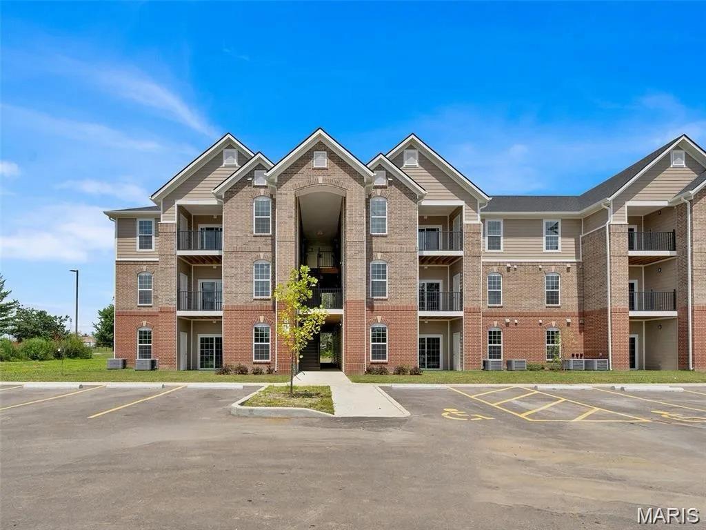 PERFECT for a person looking for a new home or an investor looking for a low maintenance property to add to their portfolio, this 1 year young, 2025 built, 2 bedroom, 2 bathroom condominium is located in the rapidly growing Dardenne Prarie location and sought after Wentzville school district  As you walk in you will be greeted with a naturally sunlit open floor plan with luxury flooring throughout. The cozy great room features 9 ft soaring ceilings, canned lighting, double paned doors, contemporary fixtures, an electric fireplace and is accessible to the covered composite balcony perfect for relaxing and offers privacy and beautiful views of trees and extra storage space. The spacious kitchen includes a deep sink and high faucet, 38" soft close custom cabinets with an amazing cooking ventilation built in, beautiful granite countertops, and complete with Whirlpool stainless steel electric range, dishwasher and refrigerator. The separate dining area is perfect for entertaining and has a pantry for additional storage. The master bedroom suite comes complete with a ceiling fan, an full bathroom with adult height vanity and a walk-in closet. Washer and dryer are included for convenience. Fantastic location, jump on the Page extension, near the Hwy 40 interchange, minutes away from Lakeside Shoppes At Winghaven, Chesterfield and Wentzville. HOA ALLOWS RENTALS!