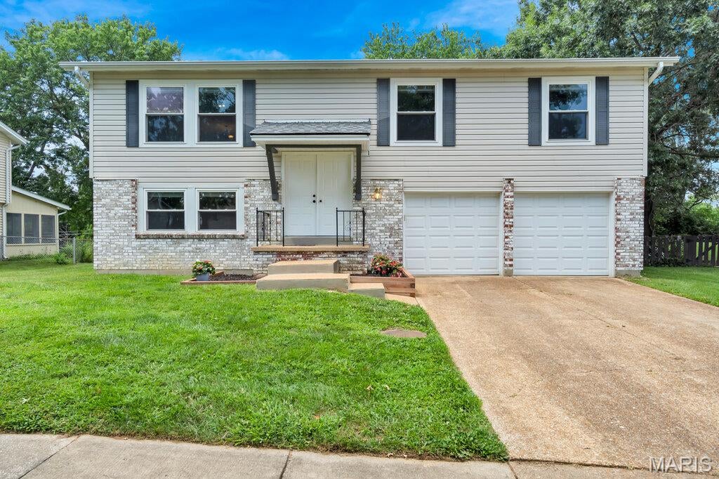 Welcome home to this beautifully maintained property offering the perfect blend of comfort, style, and privacy! No worries, a new roof was put on in 2025. Enjoy an attached 2-car garage and a backyard that backs onto open common ground and mature woods, creating a peaceful setting with no rear neighbors, and a place you may enjoy awesome sunsets on the lifetime decking. Inside, you'll find luxury vinyl plank flooring in the dining room, living room, hallway, and bedrooms, with ceramic tile in both bathrooms, and carpeting in the family room located in the lower level. The kitchen features granite countertops and stainless steel LG appliances (replaced 2023), including a gas range, providing both elegance and functionality, while white 2-panel interior doors throughout give the home a clean, modern feel. With quality finishes, a desirable layout, and a tranquil outdoor setting, this home is move-in ready and ideal for buyers seeking everyday comfort in the Mehlville School District.