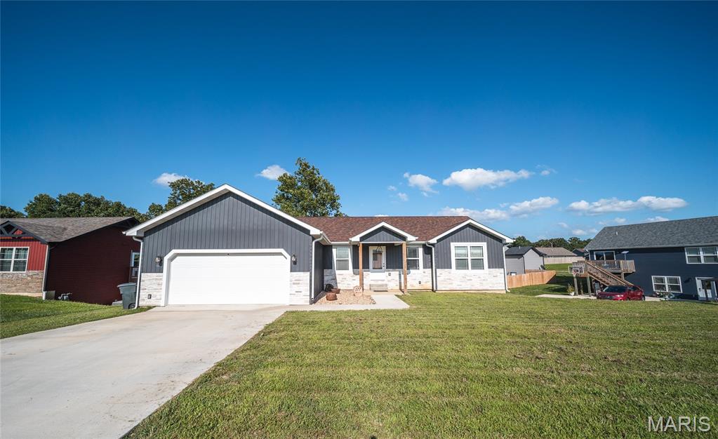 Experience modern living at its finest in this stunning 2024-built, 4-bedroom, 3-bath home located in the highly sought-after Summit Pass subdivision. Perfectly positioned just minutes from Fort Leonard Wood, this home offers the ideal combination of contemporary style, functional space, and everyday convenience. Step inside from the welcoming front porch to discover an open-concept layout highlighted by luxury vinyl plank flooring, granite countertops, a spacious center island, pantry, and an inviting kitchen and dining area designed for gathering with family and friends. The dining room opens to a covered deck, creating the perfect space to enjoy your morning coffee or unwind after a long day. The thoughtfully designed floor plan features two bedrooms on the main level, including a beautiful primary suite complete with a walk-in closet, elegant tiled shower, and stylish barn-style glass door. A second bedroom and full bath complete the main floor. Downstairs, you'll find a spacious family room, two additional bedrooms, a full bathroom, and a large unfinished storage area that offers endless possibilities for organization or future expansion. With a two-car garage, modern finishes throughout, and a layout that offers flexibility for families, guests, or a home office, this move-in-ready home has everything you've been looking for. Don't miss your opportunity to own a nearly new home in one of the area's most desirable neighborhoods—schedule your private showing today!