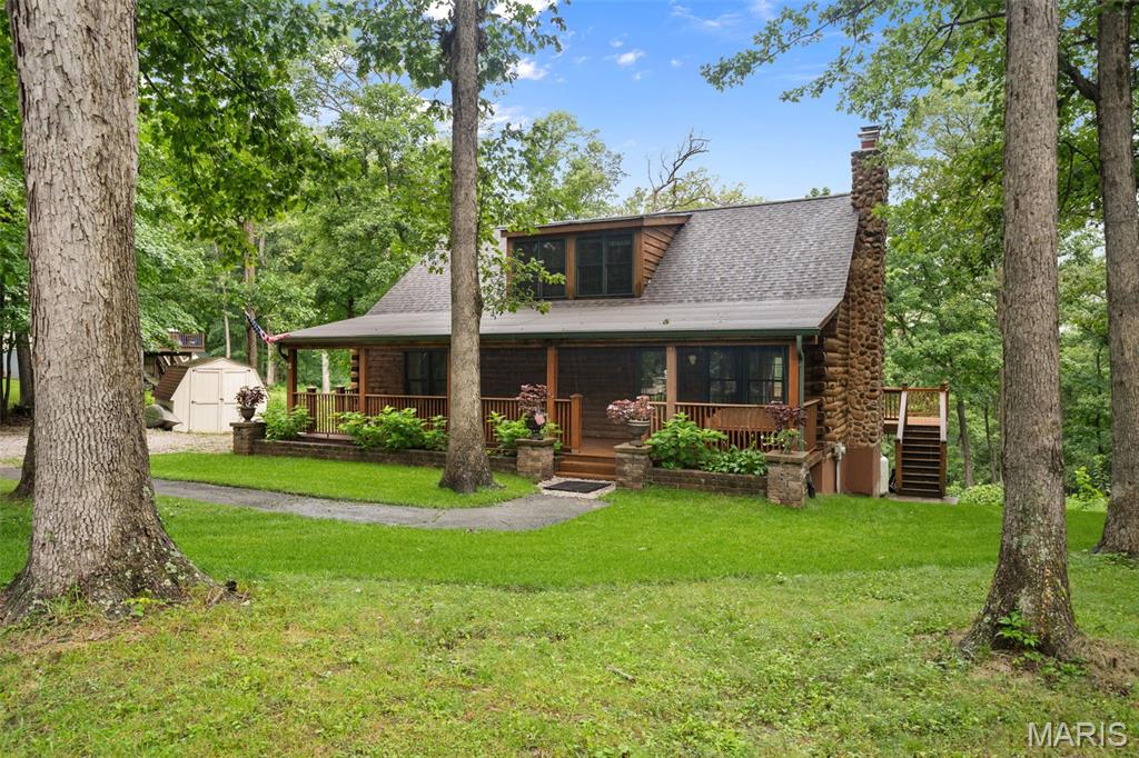 Showings Start Wednesday, August 12th! Are you looking for a truly one-of-a-kind log cabin spectacular home with 71 feet of frontage and your own private access to the Meramec River? Bring your kayaks. Here it is! Situated on 2 private acres, this gorgeous 3-bedroom, 3-full-bath custom 9" D-cut log home offers incredible character, peaceful surroundings and stunning river views.
From the dreamy covered front porch with swing, step inside to soaring 16' vaulted beamed ceilings and an impressive two-story stone wood-burning fireplace that anchors the main living space. The remodeled eat-in kitchen features custom-painted cabinetry, soft-close drawers, pull-out storage, quartz countertops and island, newer appliances, plus a separate oven and convection microwave. Perfectly appointed LVP flows beautifully on the main level living spaces. 
The main level offers a bedroom, full bath, bonus office/bedroom, and access to the expansive deck overlooking your private oasis. Upstairs, you'll find a loft-style primary suite, while the finished walkout lower level adds even more living space with a family room centered around a second stone fireplace, a spacious sleeping room, a full bath, and laundry.
Major updates include beautiful new landscaping, architectural roof ’26, Culligan whole-home water treatment system, HVAC ’23, water heater ’26, drainage system with sump pump, new well pressure tank and gas fireplace logs. Outdoor storage shed, all appliances & white display cabinets stay!
Enjoy the serenity of riverfront living while remaining conveniently located near Highway 44 and just feet from Brookdale Farms. A truly special property offering rustic charm, modern updates, and a setting that is hard to duplicate!
