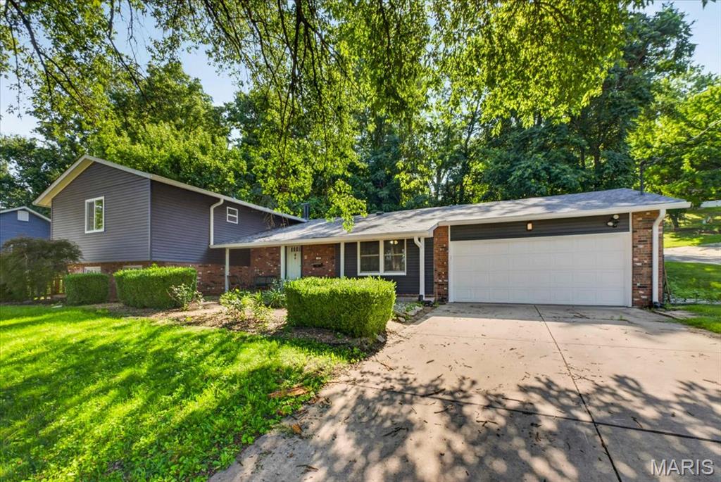 This well-maintained split-level offers 5 bedrooms, 3 bathrooms, multiple living spaces, and a unique lower-level living area that is ideal for multigenerational households, extended guests, or anyone looking for added privacy.

The main level is designed for both everyday living and entertaining. The spacious living room opens to the dining area and features a sliding glass door leading to the backyard, creating an easy indoor-outdoor flow. The kitchen is equipped with a desirable 6-burner gas range, stainless steel refrigerator, abundant workspace, and a charming drop zone/pantry complete with built-in bench seating beneath a large front window—perfect for organizing backpacks, groceries, or simply enjoying your morning coffee.

Upstairs, you'll find four bedrooms, including a generously sized primary suite with a private ensuite bathroom. Two additional bedrooms offer comfortable space for family or guests, while the fourth bedroom is perfectly suited as a nursery, home office, hobby room, or workout space. A second full bathroom serves the remaining bedrooms.

The lower level adds exceptional versatility with a spacious fifth bedroom, family room with a full second kitchen, full bathroom, and laundry room. A separate exterior entrance provides direct access to the side yard and a dedicated two-car gravel parking pad, making this level an excellent option for multigenerational living, long-term guests, or anyone seeking additional privacy and independence.

Outside, the backyard is ready to enjoy with an oversized patio that offers plenty of room for outdoor dining, entertaining, or relaxing. Two backyard swings create inviting spaces to unwind, while a storage shed provides extra room for lawn equipment and seasonal items. Garden enthusiasts will appreciate the established garden area located beside the home.

Car enthusiasts, hobbyists, and those needing extra storage will love the oversized attached two-car garage, which includes an additional room in the rear that is perfect for a workshop, storage, crafting space, or home projects.

Conveniently located near shopping, dining, parks, schools, and interstate access, this home combines generous square footage, flexible living arrangements, and practical features.