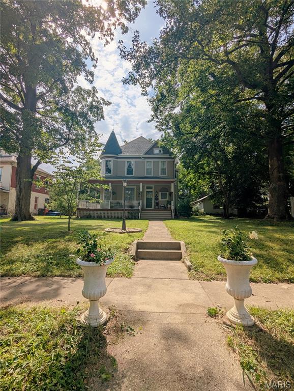 Nestled among the stately historic homes of Greenville's beloved Piety Hill neighborhood, this remarkable 3-bedroom, 2-bath Victorian wears its age beautifully. It's the kind of house that makes you slow down as you step through the front door, wondering about everyone who has admired that staircase before you.

And what a staircase it is: gloriously unpainted, the original woodwork is enough to stop you in your tracks. Soaring ceilings make every room feel grand, while enormous working pocket doors remind you that craftsmanship once came standard. Original moldings frame nearly every room, and the elaborate decorative inlaid hardwood floor, originally ordered through the Sears catalog, is a conversation piece all its own. The stunning fireplace is practically begging to become the centerpiece of your holiday decorating. (The current owner does recommend having it inspected, and possibly repaired, before enjoying a roaring fire.)

Then there's the turret.

Rising two stories and wrapped in beautiful rounded windows, it adds just the right touch of storybook charm. Whether it becomes your reading nook, home office, or favorite place to watch a summer thunderstorm roll through town, it's impossible not to fall a little in love.

The home has been thoughtfully updated where it matters most. Modern bathrooms and a practical, functional kitchen blend seamlessly with the original architectural details, creating a home that honors its history without asking you to live in the past. And unlike many historic homes, storage isn't an afterthought. The primary bedroom closet is downright enormous, and the full basement gives you plenty of room for keepsakes, seasonal décor, and whatever else life accumulates along the way.

While the floor plan isn't the wide-open concept of a new build, the rooms are surprisingly generous, offering nearly 3,200 square feet of distinctive living space. Above the second-floor bedrooms, a spacious unfinished attic is just waiting for its next chapter. Library, hobby studio, family room, guest retreat...or simply incredible storage. The choice is yours.

Outside, the welcoming front porch practically begs for porch swings, iced tea, and conversations that last longer than planned. The backyard is charming and manageable, while the generous front yard provides plenty of room for flowers, landscaping, and a little gardening without demanding every spare summer weekend.

Piety Hill has long been one of Greenville's most treasured neighborhoods, known for its remarkable collection of historic homes and local lore that includes whispers of Underground Railroad connections. Whether those stories prove fact or folklore, there's no denying this neighborhood carries a sense of history that's difficult to replicate.

If you've been waiting for a home with character, craftsmanship, and just the right amount of delightful eccentricity, this quirky old broad is ready to charm her next owner. Some homes ask you to picture your furniture inside. This one asks you to imagine your place in a story that's been unfolding for well over a century.