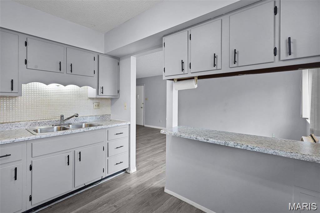 Affordable, convenient and move-in ready! This clean, updated ground-level condo in Hazelcrest III offers 2 bedrooms, 1 bathroom and 806 square feet of comfortable living space. Inside, you’ll find freshly painted rooms, newer laminate flooring, newer vinyl windows, generous closet space and a beautifully remodeled bathroom. The refreshed kitchen features revitalized cabinetry, updated countertops and a convenient breakfast bar overlooking the spacious living area. Enjoy outdoor living on the private covered patio, accessible from both the kitchen and one of the bedrooms. Additional highlights include a newer roof and easy ground-level access. The monthly condo fee includes water, sewer and trash. Conveniently located off Dunn Road near the I-270 and I-170 interchange, with easy access to major employers, St. Louis Community College and Lambert International Airport. Don’t wait—schedule your showing today!