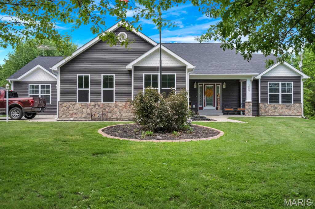 This well-maintained ranch is only FIVE years old! Situated on a large park-like lot in Jonesburg offers a functional layout and quality updates throughout. The open floor plan features a spacious foyer, large vaulted family room, dining area, and large kitchen with a breakfast island & large walk in pantry. Kitchen also offers tons of tall cabinets & space. Just off the dining area is a 27-foot patio, providing additional outdoor living space. The primary suite includes a luxury bathroom with a tiled tub, separate shower, separate vanities, and a walk-in closet. An additional oversized bedroom measures 20’ x 16’ and features a walk-in closet with dual access doors. The main floor laundry room includes built-in cabinetry, while the adjoining mud room offers additional cabinetry and counter space for storage and organization. Large 3 car garage is finished. This home offers dual HVAC systems, tons of natural lighting & recessed lighting throughout, ceiling fans in all bedrooms and many more upgrades. The attic provides ample storage for seasonal items and additional household needs. Walk to shopping, parks and dining!